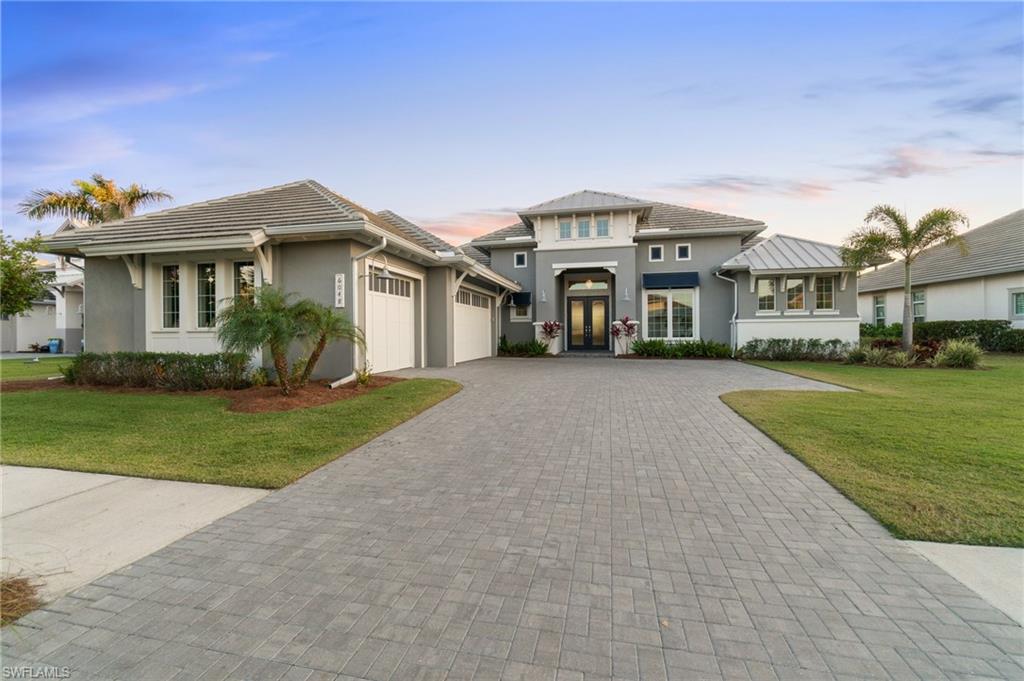 Welcome to 6048 Plana Cays Drive, a stunning home in the highly desirable Isles of Collier Preserve. This spacious Stock Development Cocoplum model features four ensuite bedrooms plus a den, a bright, open floor plan, and exquisite coffered ceiling details that add a touch of elegance and architectural charm. Oversized glass sliders seamlessly connect the indoor and outdoor living spaces, offering beautiful views and creating a perfect flow for entertaining. The gourmet kitchen is a chef’s dream, complete with a high-end gas range, premium appliances, and ample storage. The true highlight of this home is the breathtaking outdoor living space, featuring a custom-designed pool with elegant fire bowls that create a warm and inviting ambiance. The outdoor kitchen is ideal for entertaining, equipped with premium appliances, generous counter space, and a covered seating area for dining al fresco. Whether you're relaxing by the pool, hosting gatherings, or enjoying the serene surroundings, this home offers the ultimate Florida lifestyle! Residents of the Isles of Collier Preserve will also enjoy resort-style pools and amenities, including a state-of-the-art fitness center, tennis, pickleball, and bocce courts, dog park, cabanas and on-site dining options. The Isles Club offers scenic trails, exercise stations, and Nature Watch areas, while watersport enthusiasts can explore the Cypress Waterway from the boathouse, dock, and kayak launch. Additionally, Hamilton Harbour, a prestigious private yacht club and marina located on the shores of Naples Bay, offers exclusive memberships with direct deepwater access to the Gulf of America. This makes the home an ideal retreat for boating enthusiasts and those seeking the ultimate coastal lifestyle. All this, just minutes from pristine beaches, top-rated golf courses, and fine dining!