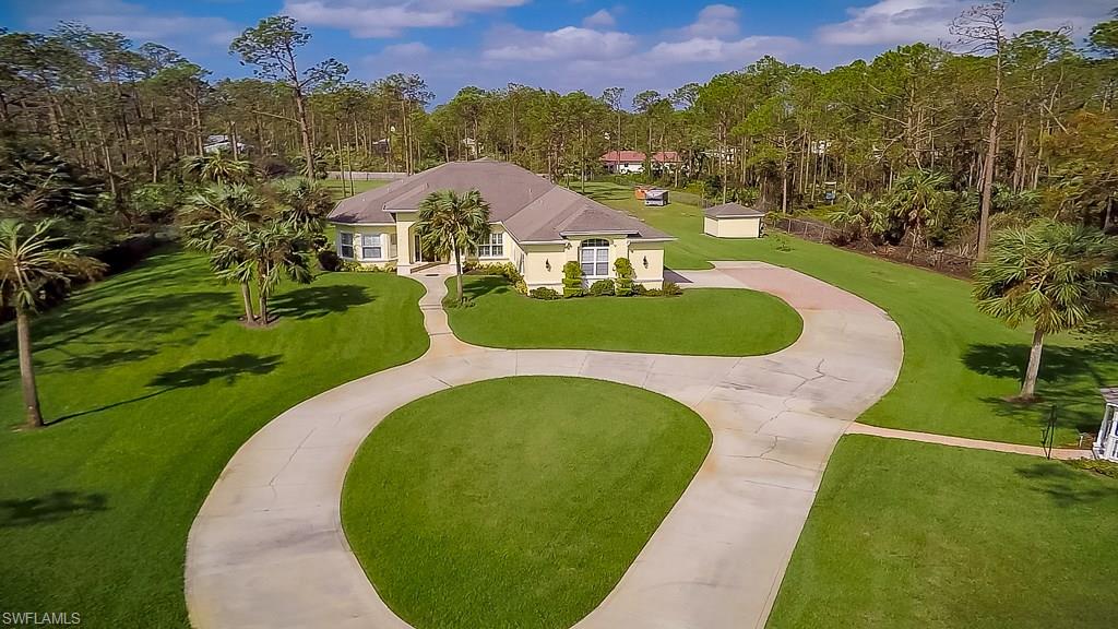 Magnificent home built by contractor for his own use on 2.7 acres of land.  Many upgrades throughout.  Open concept with coffer ceilings, sound system throughout the home, lanai and gazebo, perfect for entertaining. Well designed for multiple use of the den and office, perfect for an art studio or sewing area.  Attached 2 car oversized garage (27 X 25) and detached building used as a workshop with 14 ft rolled door.  Plenty of room for an RV, boat or additional garage space. New water system installed in 2017.  Front yard irrigated with 12 zones, newer kitchen appliances.  A must see!