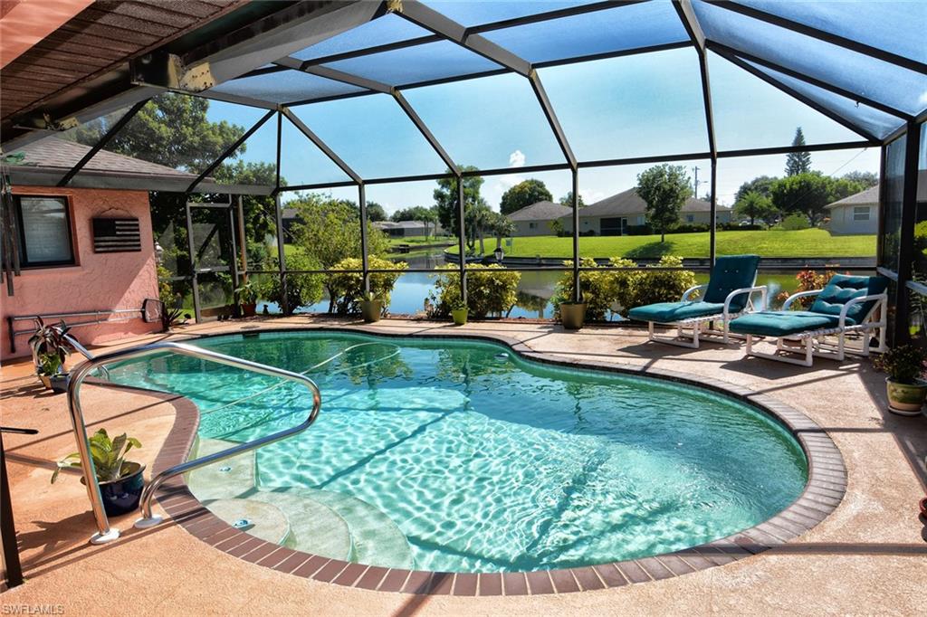 BEAUTIFUL SE CAPE CORAL, 3BED/2BA, 1698 Sq Ft WATERFRONT, POOL HOME WITH INTERSECTING WATER VIEWS! Enjoy boating through miles of canals with access to Manatoba Lake! This well maintained waterfront home is located on a quiet manicured street with beautiful landscaping and curb appeal, plus it is outside the flood hazard area, so flood insurance is not mandatory in this zone. This wonderful floor plan offers separate conversation areas throughout the home, featuring a large living area, dining area, family room/den with beams and a stone woodburning fireplace, an updated kitchen w/modern cabinetry & newer appliances. The master bedroom suite is split opposite side from the add'l 2 guest bedrooms w/walk-in closets & pool bath. Some of the many features include 3 large sets of glass pocketing sliders opening to the pool area & oversized lanai, a kitchen pass through window, high ceilings in family room, resurfaced pool, plumbing repipe 2009, New AC Change Out 2011, Sprinkler System, Roof 03/2003, Concrete Boat Dock, Seawall, City Water/Sewer Paid. Enjoy lime & avocado trees too! You simply won't find a better value, call today for an appointment to view, you will be so happy you did!