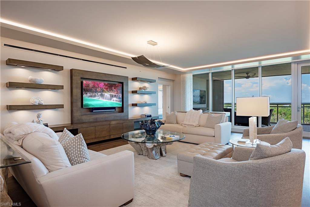 Price reduced over $700K since December,  enjoy remainder of this season with immediate occupancy. Welcome to Kalea Bay unit 602, a sophisticated  turn-key furnished Sky Home in Kalea Bay.  Step off the elevator directly into your expansive home of just under 3300SF of interior space.  Amazing views through walls of floor to ceiling glass to Wiggins Pass and sunsets over the Gulf. Relax on the 500+ SF curvilinear designed lanai with contemporary glass rails and recently installed hurricane shutters.   Popular Great Room floor plan seamlessly combines style and function and includes 3 bedrooms and 3.5 baths along with spacious Den/Office.  The welcoming Great Room is enormous with multiple seating areas and wood toned custom entertainment wall with lighted floating shelves. All floors throughout unit are Legno Bastone wide plank hardwood and complement the neutral toned transitional furnishings.  Gourmet white kitchen features Wolf and Sub-Zero appliances including natural gas cooktop and adjoining Butler Pantry has wine cooler.   Master suite features floor to ceiling western views and has opulent bath with floating tub, dual vanities and generous sized walk- in custom closet.  Two guest rooms are ensuite and located on opposite side of unit affording privacy for all.  Recent upgrades include fresh paint, wallpaper and updated window treatments including electric shades in all rooms. Unit has stunning lighting with full Lutron automation. Tower 100 includes amazing gallery type entrance lobby with captivating mural sized photographs.  The roof top features roof top pool, sky lounge and open-air fitness area.  World Class amenities continue at the 100,000 SF Kalea Bay Club amenity center featuring 3 pools, two restaurants, expansive decks, two open air bars, teen lounge/kids room and State of the Art Wellness Center.  Convenient to the Club are also 4 tennis courts and 8 pickleball courts.  Your guests that appreciate an extra level of privacy can also enjoy overnight accommodations at the on- site Bay Cottages