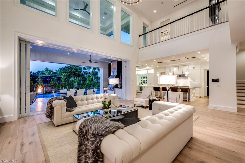 "The Audrey", was created to embody the spirit of today!Danison Homes presents an absolutely awe-inspiring and iconic new designed waterfront estate situated in Aqualane Shores in an ideal setting just steps to historic 3rd Street amenities and a few short blocks to Naples pristine beaches.Infused with contemporary elegance and an expansive open floor plan, gourmet kitchen with top of the line appliances and cabinetry throughout,formal dining area with climate-controlled wine cellar,study, wet bar,private elevator,27 KW whole home generator,2 laundry rooms and three-car garage. Two first floor bedrooms, including a generous master suite plus a large study with three bedrooms upstairs and 2nd level living area and covered balcony are perfect for larger parties. This unique and special offering boasts wide water views and offers an unparalleled combination of attributes including solid concrete construction, energy efficient materials, natural stones and woods, retractable screens and shutters and Lutron smart home technology. The amazing pool and spa look like it are bordered with pearls. The artfully designed expansive outdoor area is complete with a new seawall and 80” new dock.