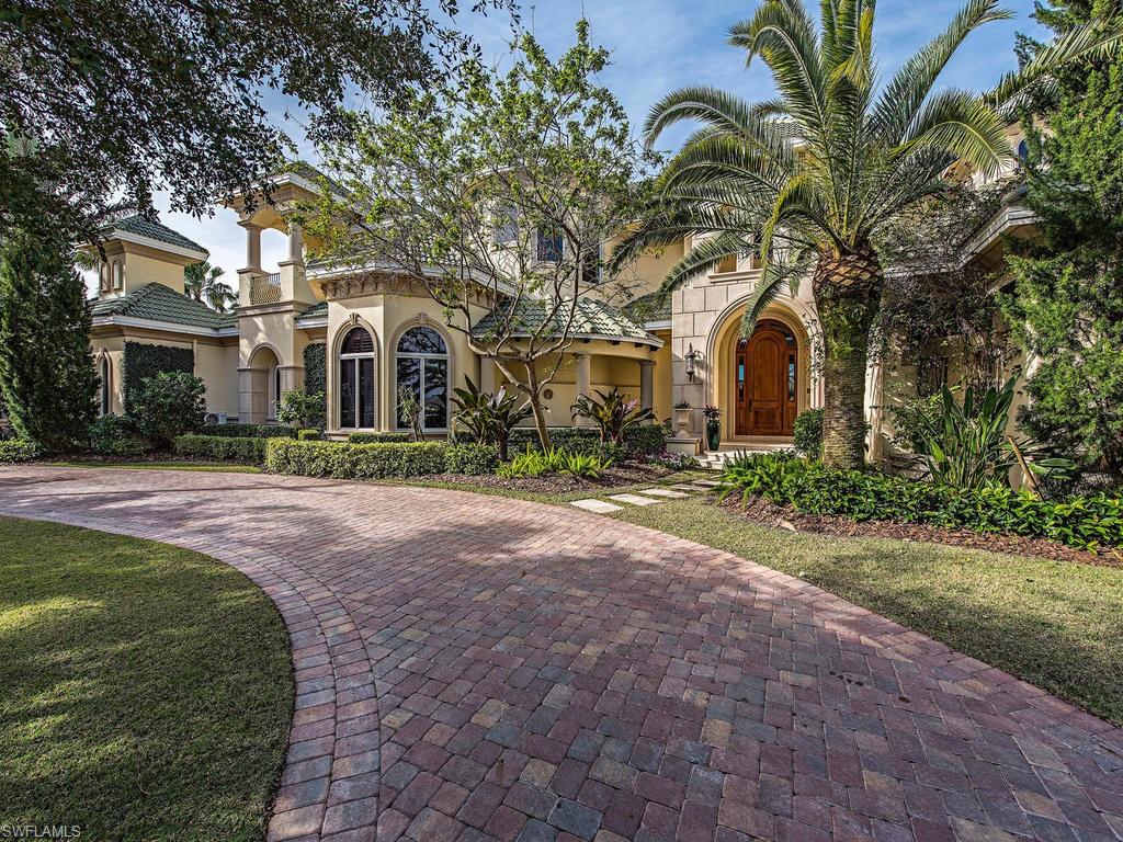With 131 ft. of water frontage this is a boaters paradise.  Freshly painted inside and out this exceptionally well maintained property is perfect for entertaining. There are multiple offices/dens an outdoor kitchen, lanai with pool, spa and fireplace.  The expansive wrap-around upper floor terrace has panoramic views.  The designer master suite with its imported hand carved travertine tub. 70 ft floating dock, lift for 2 jet skis, and an additional lift for a 30 ft boat.  4 car garage with 2 built in lifts. (6 car total) Port Royal Club membership eligibility.