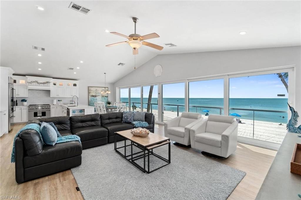 Looking to own a beach front home that will pay all expenses plus profit and still let you enjoy the weeks you desire - you have found it. Investors - home is booked nearly year round with 5 star reviews and is kept in immaculate condition. “Copacabana on Bonita Beach” is sold turnkey furnished in contemporary coastal style and there are bookings in place with rental history for review. This 2 story Bonita Beach Gulf front home offers 3,230 total living sq ft and 1,725 AC sq ft with 3 bedrooms & 2.5 baths ideally located in the southern most part of the island.   This beautifully renovated DIRECT BEACHFRONT home is finished iwith a light, bright, coastal contemporary design and as you reach the top of the stairs all you see, feel and hear is the surf of the turquoise waters and white sand beach of the Gulf.  The open floor plan provides simple easy beach living and includes: house-wide pocketing sliding glass doors, cable wire railing for unobstructed views, all hurricane impact glass/sliders, vaulted ceilings, solid interior doors & designer plumbing and light fixtures. The kitchen features quartz counters with subway tile backsplash, white custom cabinetry to the ceiling with modern chrome fixtures & soft-close drawers, stainless-steel farmer’s sink with chef’s faucet, Subzero glass door refrigerator, Wolf 48” gas range with high output hood above & built-in Sharp microwave. Baths have quartz counters, white cabinetry/vanities, frameless showers with mosaic & subway tiles and Kohler one-touch commodes. The large great room and dining room also sit right over the water.  The master bedroom includes a master bath with modern specialty sink with dual faucets & multiple shower heads in the large shower. Guest bedroom two offers two sets of built-in bunk beds allowing sleeping for 4. Guest bedroom three, guest bath and laundry complete the one level living.  The lower level includes a 2-car garage,  storage and beachfront entertainment area with plenty of room for a Gulf-front pool.  Walk to restaurants, jet ski rentals, boat rentals, para-sailing. Mercato, Promenade, Coconut Point, entertainment, golf courses and the International Airport are all nearby. Note: The property next door to the north is also being sold by Seller with same great rental history and current bookings in case you are looking for a larger rental property investment MLS 226002023.