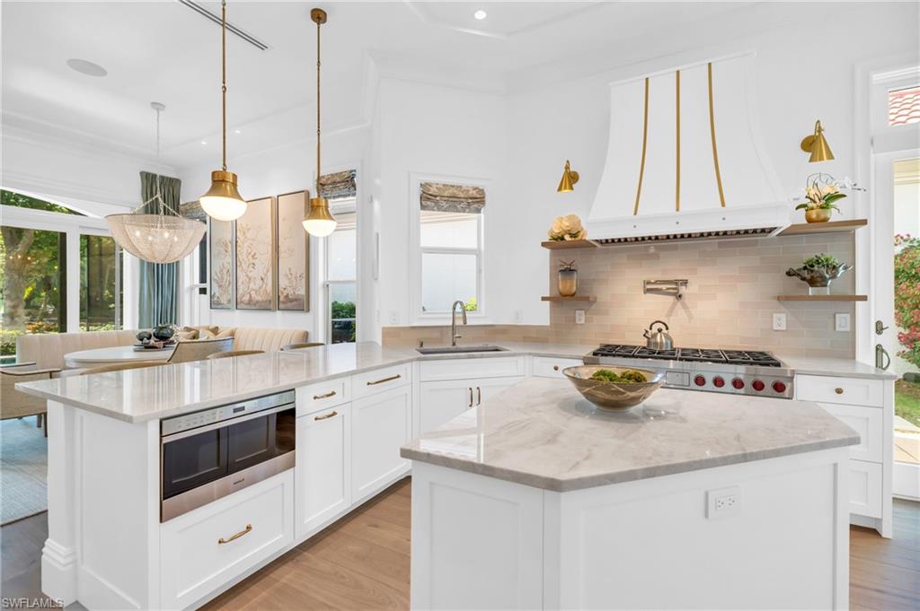 Nestled in the exclusive enclave of Villa La Palma at Bay Colony, this stunning two-story home offers an unparalleled blend of luxury, privacy, and effortless living. Thoughtfully remodeled down to the studs, this meticulously maintained residence spans nearly 4,000 square feet and embodies warmth and sophistication at every turn. Its coveted southwestern exposure bathes the home in natural light throughout the day, with breathtaking views of the serene waterscape providing a picturesque backdrop to the expansive pool and spa area. Step inside to discover a spacious and inviting layout, featuring four elegant bedrooms, each with its own en-suite bathroom, and a versatile loft that can function as a den, office, or additional sleeping quarters. The primary suite is a private retreat, boasting a spa-inspired, newly renovated bathroom with dual vanities, an oversized walk-in shower with multiple showerheads, and a luxurious soaking tub—creating the perfect sanctuary for relaxation. The heart of the home is the chef’s kitchen, which has been completely upgraded with top-of-the-line appliances, including a Wolf gas cooktop, Subzero paneled refrigerator, and dishwasher. The kitchen also features new countertops and ample storage, making it a culinary enthusiast's dream. Additionally, you will find two sub zero built in ice makers. Entertaining is made effortless with a separate dining area and sliding glass doors that seamlessly connect the indoors to the poolside oasis. This villa offers an array of modern amenities, including hurricane-rated windows, automatic lanai screen shutters, new sliding glass doors, and a new pool heater. No details were overlooked, including the unique panoramic pool screen, which provides a clear view of the lush landscaping and waterscape. The two-car garage, outfitted with new epoxy flooring, built-in refrigerator/freezer and built-in enclosed custom cabinets, provides ample storage for vehicles and prized possessions. Additionally, the property is equipped with a new underground propane tank that supplies gas lines to the oven, outdoor grill, and allows for a future gas hot tub heater. Living in Villa La Palma is the epitome of luxury living with homeowners' association coverage for essential services such as cable/internet, landscaping, and pool maintenance, offering all the benefits of single-family living without the hassle. Residents of Bay Colony enjoy exclusive access to the private Bay Colony Residents Only Beach Club, a newly updated tennis center, plus all the coveted amenities of Pelican Bay, including pristine beaches, scenic nature trails, and a lifestyle of unrivaled elegance. Ideally located just minutes from the upscale shopping and dining experiences at Mercato and Waterside Shops, this villa presents an extraordinary opportunity to experience the very best of Naples luxury living. Don’t miss your chance to own a piece of paradise in one of Naples’ most prestigious communities.
