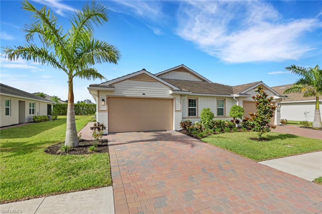 Discover modern living in this stunning twin villa located in the desirable gated community of Enbrook. This 2 bedroom plus den home offers 1,503 square feet of bright and airy space, complete with a 2 car garage featuring a custom epoxy finish. Step inside to find sleek tile flooring throughout and impact resistant windows and doors for peace of mind. The open layout seamlessly connects the great room, dining area, and kitchen, perfect for entertaining. The spacious kitchen is a true highlight, featuring a large island with seating, white shaker cabinetry, stainless steel appliances including a French door refrigerator, and stylish light countertops. French doors to the den, and a smart split floor plan provide versatility for a home office or guest suite. Enjoy privacy in the owner's suite, which boasts a walk in closet and a private bath, while the secondary bedroom and guest bath are thoughtfully separated. Outside, the screened lanai overlooks serene greenery, extending your living space while ensuring privacy. With a durable stucco exterior, tile roof, and recent construction that meets current Florida building codes, this villa offers both style and low maintenance. Enbrook caters to an active lifestyle, featuring amenities like a resort-style pool, lap pool, pickleball and tennis courts, bocce ball, billiards, a fitness center, and clubhouse. Enjoy convenient access to US 41, Marco Island beaches, downtown Naples, and a vibrant array of dining and shopping options.