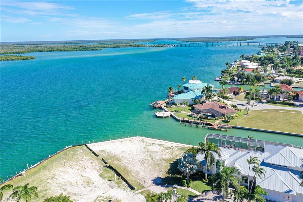 Discover this fantastic opportunity to own one of Marco Island's premier waterfront homesites. This lot is ready for you to develop your own hideaway in paradise, with an astonishing new riprap-protected, 171-foot, commercial-grade seawall, where you can simply look over the edge and see thousands of baitfish attracting larger marine life. Orange Court is adorned with newly constructed, spectacular homes and is one of the most sought-after locations, as it allows convenient travel on and off the island. You will enjoy solitude and breathtaking, unobstructed panoramic views of the Marco River, mangroves and the brilliant lights of the S.S. Jolley Bridge in the distance as you are tucked on the point of a secluded cul-de-sac. The large water frontage allows for a variety of docking choices for several watercraft without impeding the gorgeous scenery. From your backyard, you can watch dolphins play, catch fish from your dock or take a quick boat ride or Sea-Doo to the legendary Snook Inn. This is the perfect location for avid boaters, offering deep-water direct access to the Gulf of Mexico. Build your dream home on this rare lot and enjoy all the lifestyle Marco Island has to offer.