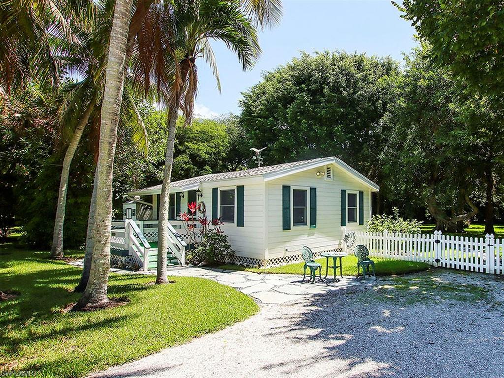 Charming Sanibel cottage on a beautifully landscaped property. Located on the quiet end of West Gulf Drive on a private sandy lane just a few yards from the deeded beach access. Enjoy some of the best shelling in the world or take a short leisurely bike ride to the J.N. “Ding” Darling National Wildlife Refuge from this great location. This cottage is reminiscent of Old Sanibel. Built in 1968, the home has been beautifully maintained; original hardwood floors, AC, a large screened lanai, two bedrooms, living room, and galley kitchen. The large yard is an oasis, shaded with beautiful mature trees and fully fenced. A UNIQUEOPPORTUNITY to purchase the adjacent lot to build your dream home on and keep the Sanibel Cottage as a pool/guest house and own one of most beautiful estates on Sanibel.