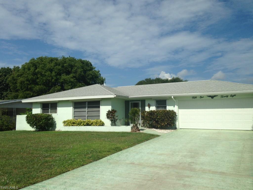 Wow!  Gulf Access and Move in Ready for $209,900!  This home is located less than a mile from the river and only 1 bridge and an 8.5 foot clearance. As you arrive you will notice the nice landscaping and also this home has a two car garage.  As you enter you will see the tiled entrance way with access to the kitchen and also the Great room / Dining area.  The master bedroom features large windows with a sliding door out to the rear Florida room and a walk in closet.  The master bath has a tiled shower with a single vanity.
The second bedroom has large closets and lots of windows.  The second bathroom features tiled tub / shower combination and a large vanity.  The kitchen has new counter tops, ample cabinets and a garden / serving window out to the Florida room.  Of the kitchen is a small den / office with an entrance to the garage.  This two car garage has the laundry in it and also a half bath for cleaning up after those outdoor projects.  Also this house has a screened porch / lanai looking out at the water.  This large lot can easily accommodate an addition to the house or a large pool.  Western rear racing to see those beautiful sunsets.  See this now before it is gone!
