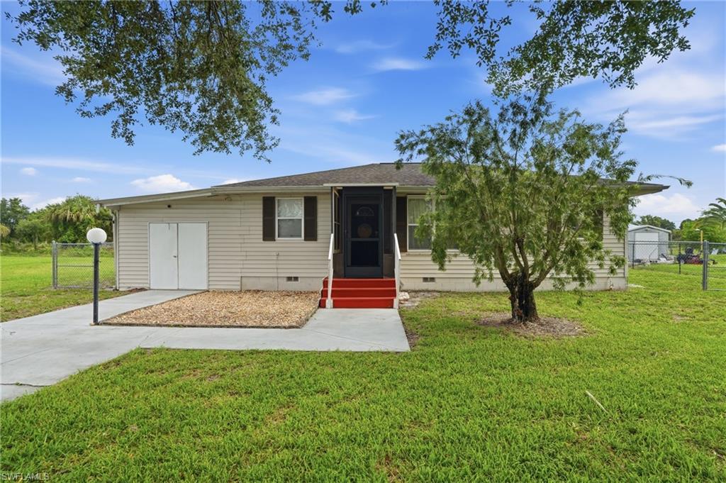 This is a must-see opportunity in the desirable Southwest Lehigh Acres area! Perfect as a starter home, this well-maintained residence offers 3 bedrooms, 1 bathroom, and an attached garage. Recent updates provide peace of mind, including a NEW A/C system and ductwork (2024), new interior paint, new ceiling fans, and a new well water system (2021).

The spacious floor plan extends to a large screened rear lanai, ideal for entertaining family and friends year-round. The fully fenced backyard offers plenty of room for children and pets to play, while the attached workshop/shed provides excellent storage and workspace options. Additional features include a new screened front entry door, stainless steel appliances.

Conveniently located with easy access to Lee Boulevard, shopping, dining, schools, and major roadways, this property combines comfort, functionality, and value. Don't miss your chance to make this wonderful home your own!