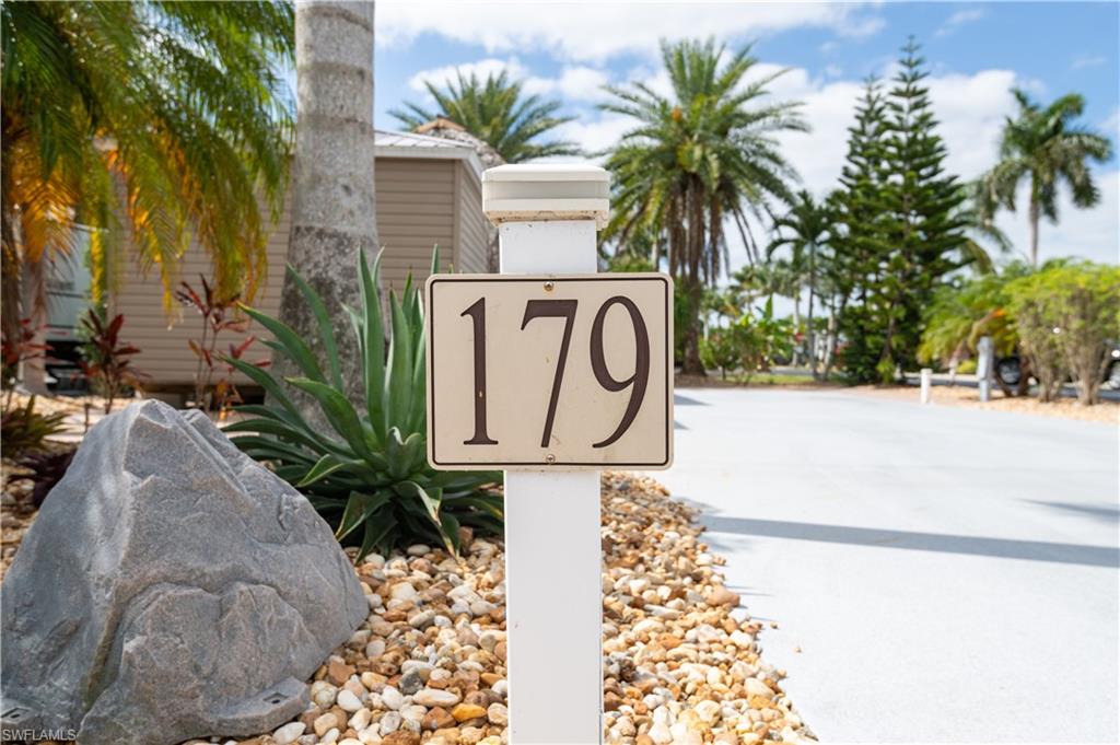 This 50’ x 90’ corner lot, thoughtfully designed with lush landscaping, mature trees, and a stunning tiki that defines exceptional outdoor living with a , and a durable stone flake polyaspartic-coated RV slab..

This landscaped paver lot features five varieties of palm trees, including a Norfolk Island pine, ponytail palm, and additional tropical plantings, all supported by a drip irrigation system for easy maintenance. Additional enhancements include accent lighting, three post lamps, multiple electrical outlets.

The impressive 16’ x 23’ timber tiki hut offers an elevated paver floor and is fully equipped with electric, a stainless steel ceiling fan, a 65-inch TV, and two Bluetooth speakers. Plumbing is already roughed in, providing the opportunity to easily add an outdoor kitchen.

A spacious 10’ x 12’  Amazon shed electrical and is plumbed for a bathroom, laundry, or office space, offering versatility for additional living or functional space.

A charming paver walkway leads through a decorative trellis and arbor to a nearby common green space, ideal for walking pets or enjoying the outdoors. Conveniently located close to the clubhouse and resort-style amenities, this lot offers both privacy and accessibility.

Come make this your own tropical oasis.