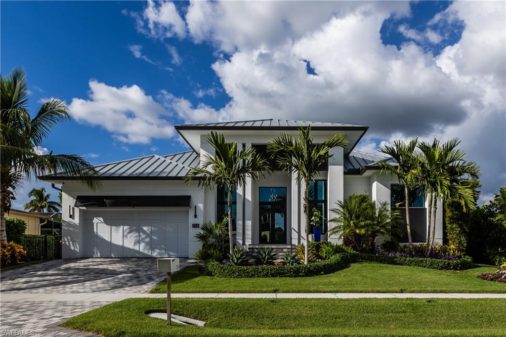Rarely available Old Marco area water direct coastal home! Luxurious Waterfront 2020 Turnkey Contemporary Home provides direct Gulf access and can be yours today! This elegant indoor-outdoor design with impeccable craftsmanship offers 4-BD, 3-Full BA with one room converted as an office with custom built cabinets is perfect for Florida's indoor/outdoor lifestyle. Quality finishes, vaulted ceilings, interior and exterior high end designer furnishings, immaculate flooring, exquisite interior/exterior Lutron lighting, Martin Logan sound system, beautiful custom motorized shades, spacious open great room & dining area w/Chef's kitchen. In ground propane tank;Generac Generator;Expansive screened in lanai to relax & entertain w/Custom BBQ area, salt water heated pool/spa w/LED lighting. Exterior is beautifully landscaped, enjoy western sunsets & long/wide water views. A boaters dream, within minutes to the Gulf from your dock, take a quick jaunt by boat to Keewaydin/Isles of Capri. Covered boat slip lift that accommodates 32' boat w/motorized jetski platform & external floating jetski/kayak platform. Two car air conditioned garage w/epoxy garage flooring. Paradise awaits!
