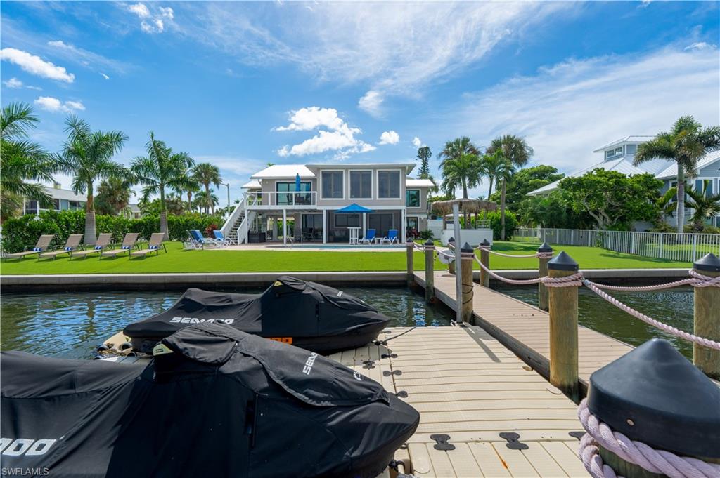 Waterfront tranquility meets exceptional rental potential at 205 Bayview Avenue. Perfectly positioned along the bay while just steps from the beach, this beautifully renovated residence offers the rare combination of peaceful coastal living and a proven income-producing opportunity on Fort Myers Beach.

Thoughtfully redesigned both upstairs and downstairs, the home features three spacious bedrooms plus a den and three full bathrooms, creating a flexible layout ideal for personal use, guest accommodations, or short-term rental income. The lower level includes a private kitchenette, allowing for independent living space, while the upper level showcases a chef’s kitchen and full bar designed for effortless entertaining.

Expansive windows frame picturesque bayfront views, where dolphins, manatees, and coastal birds are often seen gliding through the calm waters—offering a daily reminder of the relaxed island lifestyle.

Situated on a direct beach access street, the home is tucked away in a peaceful setting while remaining incredibly convenient. Located just one block north of Publix and minutes from mid-island restaurants, shops, and entertainment, the property offers the best of both worlds: quiet waterfront living with everything Fort Myers Beach has to offer within easy reach.

Whether enjoyed as a private coastal retreat, second home, or high-performing vacation rental, 205 Bayview Avenue presents an exceptional opportunity to own a versatile waterfront property in one of the island’s most desirable mid-island locations.