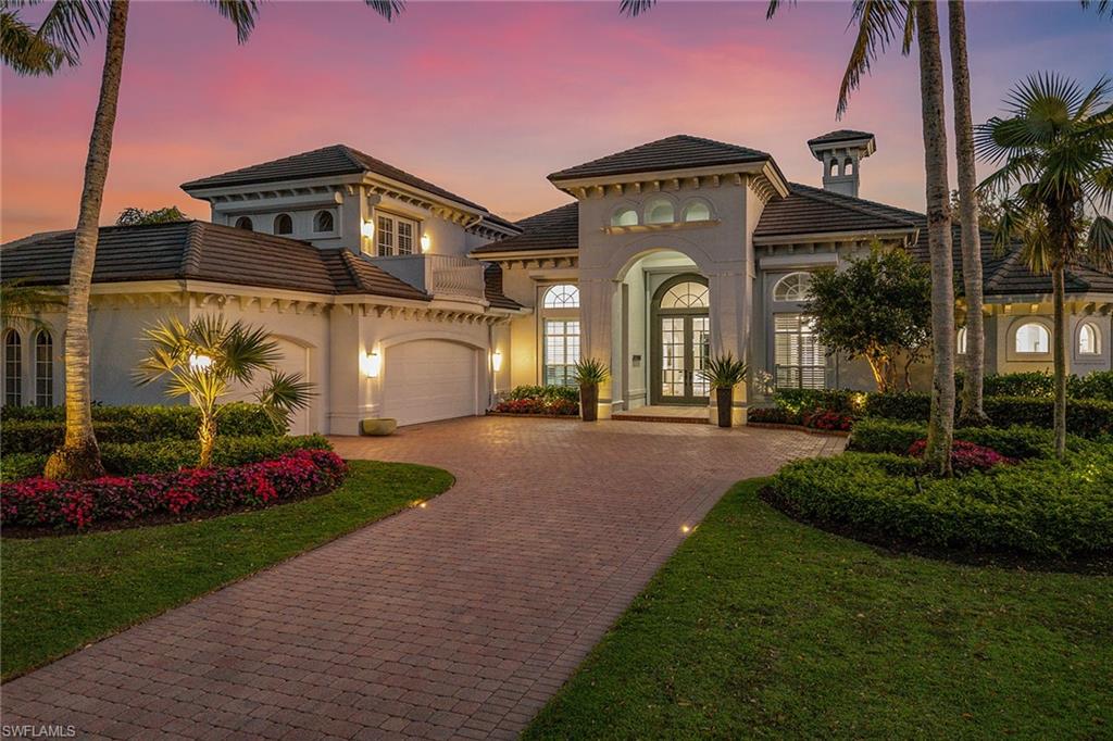 Set on a picturesque, tree-lined street in The Moorings, this elegantly reimagined residence offers an elevated coastal lifestyle in one of Naples prestigious neighborhoods. Encompassing 3,871 square feet of sophisticated interior space, this four-bedroom plus study, four-and-a-half-bath home showcases a layout thoughtfully curated for refined living and effortless entertaining. Inside, newly installed 8-inch-wide oak plank floors add warmth and texture, flowing seamlessly through the open-concept living spaces. The formal living room is anchored by a gas fireplace, while a soaring ceiling and bespoke light fixture define the dining area with architectural distinction. A custom media wall elevates the family room experience, blending form and function. The kitchen is a chef’s retreat, tastefully updated with premium appliances, quartz surfaces, and contemporary finishes that marry aesthetics and performance. All baths throughout the residence have been meticulously redesigned, featuring designer tilework, custom vanities, upscale fixtures and lighting. The primary suite is a sanctuary unto itself, offering dual custom closets and a spa-style bath that reflects a commitment to craftsmanship and comfort. Additional enhancements include a generator, Sonos home audio, designer lighting throughout, LED recessed fixtures, and new hurricane-rated garage doors enclosing the spacious three-car garage, which also features built-in cabinetry and a workbench. The outdoor living area has been transformed into a private resort setting. A saltwater pool and spa finished with new tile are framed by a marble paver deck. The expansive covered lanai and newly constructed summer kitchen invite year-round alfresco dining and entertaining, surrounded by lush landscaping and privacy. This exceptional property offers rare access to the coastal amenities of The Moorings, including proximity to the neighborhood’s private beach access, world-class shopping, dining and more. A seamless fusion of modern luxury and timeless style awaits.