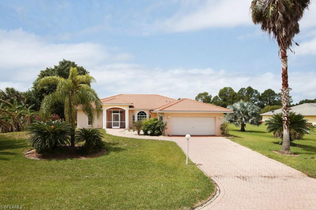 This three bedroom, three full bath SW Florida pool home is situated on a ½ acre lot with a SOUTHERN EXPOSURE in beautiful Country Club Estates. Pocket sliders and an abundance of windows provide sunshine and breezes throughout the open floorplan. It features a living room, dining room, large breakfast room, and a breakfast bar. The living area and two of the bedrooms have sliders to the spacious screen enclosed in-ground pool with spa. The tile roof, tropical palm trees, fruit trees and driveway pavers add further curb appeal. This home includes a brand new stainless steel refrigerator and microwave and a washer and dryer.  The large master suite has a trey ceiling, sliders to the lanai, and a bathroom with a double sink vanity, walk-in shower, linen closet, large walk-in closet and a separate room for the commode. The two-car garage has pull-down attic steps, an automatic garage door opener, a service door, and a window. Also included is a water softener, Central AC, Security System, ceiling fans, walk in closets, and an Aqua-link system. An excellent source of income through the existing vacation rental program or an outstanding year-round or seasonal residence.