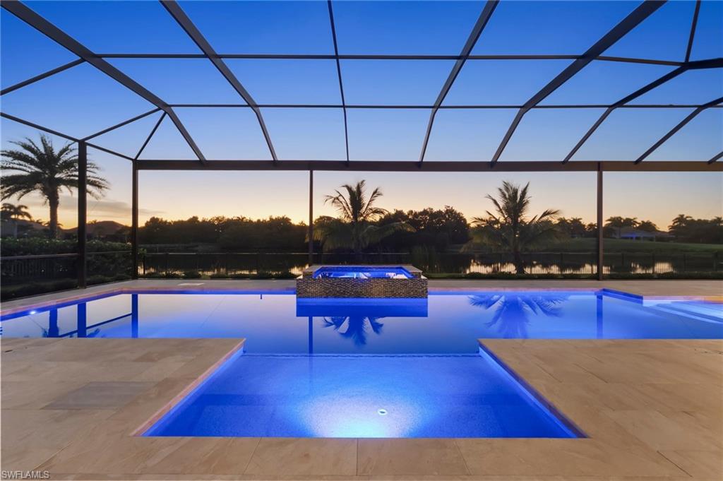 IMMEDIATE GOLF MEMBERSHIP AVAILABLE with this stunning custom home built by Florida Lifestyle. Elevated 16'1 feet above sea level and equipped with impact-resistant glass and a full-house generator, this home was meticulously designed for peace of mind and modern comfort. Every detail has been thoughtfully curated—from wide-plank Legno Bastone flooring to a 1,000-gallon propane tank, water filtration system, elevator, full security setup, and Sonos sound throughout. Beautifully furnished by Clive Daniel and Norris, this home is move-in ready for effortless Florida living. The chef’s kitchen is an entertainer’s dream, featuring dual porcelain islands, Thermador appliances, a wine refrigerator, and a spacious auto-lit walk-in pantry. A nearby bar area includes an additional wine fridge and seamlessly connects to the dining space for relaxed hosting.The luxurious primary suite offers a tranquil retreat with a custom ceiling accent, blackout shades, dual walk-in closets, and a spa-like bath with new shower heads and dual water closets. Two additional en-suite guest rooms are located on the main level in a split-bedroom layout, providing ultimate privacy.Take the elevator upstairs to a spacious fourth bedroom with double vanities and ample closet storage. This upper-level guest suite also features a lounge area, TV space, kitchenette, bar, and Sub-Zero wine cooler. The upstairs private screened lanai offers gorgeous golf views. On the main level, enjoy a generously sized laundry room with pull-out bins, extra cabinetry, a storage closet, and an additional refrigerator. The oversized four-car garage includes built-in storage, a refurbished four-seat “Hole In One” golf cart, and yet another refrigerator. For even more storage, a built-in mudroom with cubbies keeps everything organized. Entertain in style on the expansive lanai, featuring a beautiful wood ceiling, gas fireplace, covered lounging and dining areas, an air-conditioned pool bath, and a two-story panoramic cage. The fully equipped outdoor kitchen includes three TVs and custom drapes, creating an intimate yet chic setting for outdoor living. With western exposure and breathtaking water and golf course views, you’ll enjoy glorious sunsets from the gas-heated saltwater pool and spa.This home truly has it all—style, functionality, and luxury—ready for you to enjoy the ultimate Florida lifestyle.