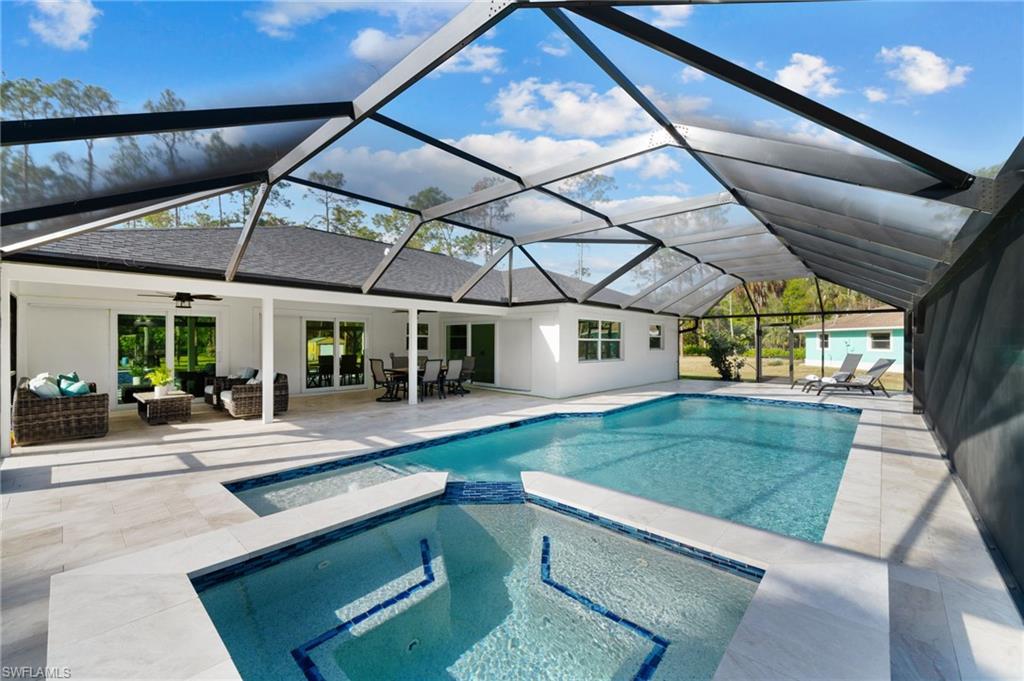 One or more photo(s) has been virtually staged, AI generated or rendered.  Sprawling 3.14-acre square homesite in the highly desirable Logan Woods neighborhood of Naples, FL, this property is a rare find offering privacy, modern amenities, and endless potential. The main house is 1,595 square feet, features three bedrooms, two bathrooms, separate dining or bonus room, a den, and a two-car garage. Completely remodeled, it boasts a newer roof, impact windows and doors, and stylish porcelain plank floors throughout. The light and bright kitchen is a chef’s dream with Taj Mahal quartz countertops, newer appliances, and contemporary cabinetry. Both bathrooms have been fully updated with elegant finishes, and the home is equipped with a newer AC unit and hot water tank for modern comfort. A highlight of the property is the saltwater pool and spa with a screened enclosure, added just a year ago, providing the perfect space for outdoor relaxation and entertainment. Adding versatility to this estate is a separate guest house with one bedroom and one bathroom. The guest house has also been completely remodeled and features a modern kitchen with white shaker cabinetry, luxury vinyl plank flooring, and a beautifully updated bathroom. The property is fully fenced with two gated entrances and surrounded by a lush Clusia hedge for unparalleled privacy. Recent land studies confirm the site is all uplands—high and dry—making it ideal for a future custom-built home while utilizing the existing home as a guest house. Both homes are equipped with reverse osmosis water systems, and a shed provides additional storage space. Located just a short drive from Gulf of Mexico beaches, fine dining, upscale shopping, airports, medical facilities, and top-rated schools, this property offers the perfect blend of tranquility and convenience. Logan Woods remains one of the most sought-after areas in Naples, making this estate a prime investment. Don’t miss the opportunity to own this unique slice of paradise!