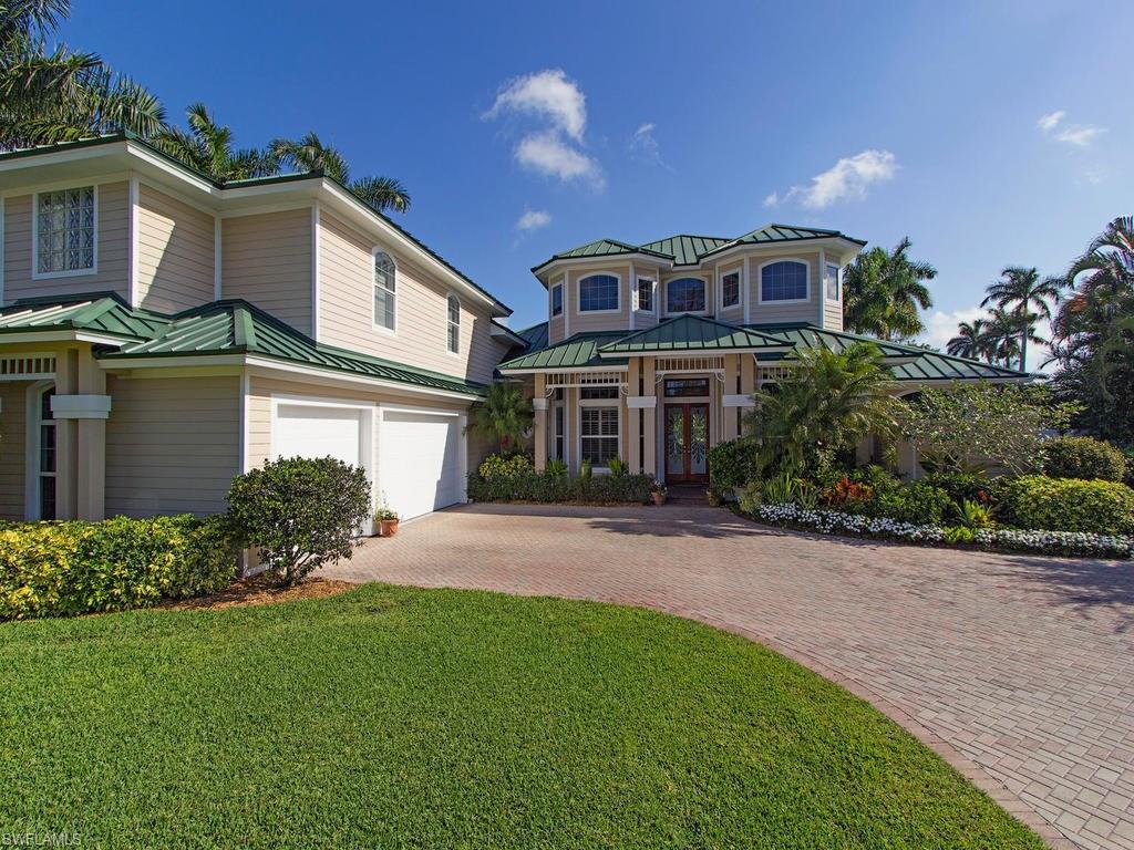 H.12440 -Love the House, love the location, love the view - Unique opportunity to own a fabulous Floridian-style Old Naples Lakeside Home, bright two-story 5 bedroom House on half acre lot with separate guest cottage. An easy walk to see the sunset, only 3 blocks from the beach & close to both 5th Avenue South & 3rd Street South with all the lovely restaurants & shopping opportunities. Brand new light English oak floors, 3 new a/c units, bright kitchen & family room, this home also has a bedroom suite for guests or children, with the option of either a playroom or a sitting room. On the second floor a large walkout balcony with relaxing lake views are perfect for sitting al-fresco, along with a private, fully fenced patio & garden area for entertaining family & friends, with vanishing edge pool & spa. Volume ceilings, spacious living, 3 car garage, with separate entrance for the guest residence make this home a wonderful place to enjoy Naples year round. An option to build a small dock on the lake allows you to fully take advantage of this beautiful location.