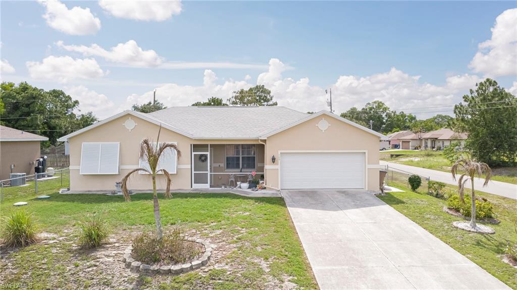 Beautiful 4-bedroom, 2-bath home with a 2-car garage situated on a desirable corner lot in Lehigh Acres. This well-maintained property features tile flooring throughout the main living areas with carpet in the bedrooms for added comfort. The spacious kitchen is equipped with stainless steel appliances, and the home includes a washer and dryer for your convenience. Enjoy outdoor living in the screened lanai overlooking the fully fenced backyard, perfect for entertaining, pets, or family gatherings. Major updates include a new roof and fence installed in 2023, along with awning shutters added in 2021 for added peace of mind. Conveniently located in a desirable area of Lehigh Acres with easy access to Fort Myers, shopping, dining, schools, and major roadways. Don't miss this opportunity to own a move-in-ready home in a great location!