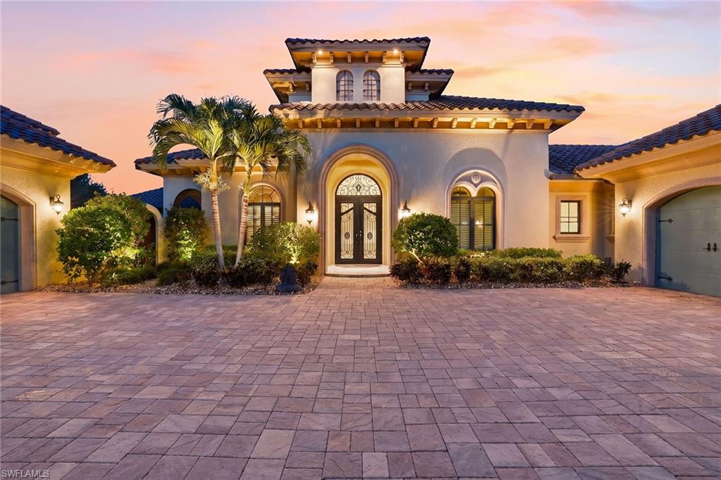 Welcome to elevated living in the Terabella neighborhood of Renaissance! Built by renowned builder Bill Stancel, this timeless custom estate blends exceptional craftsmanship, architectural detail, and sweeping views of the lake and Hole #9 of the Arthur Hills Championship Golf Course. Ideally positioned to capture beautiful sunrise views across the lake and golf course, the residence seamlessly connects the interior living spaces with an exceptional outdoor setting. A grand circular paver driveway, lush tropical landscaping, and striking architectural lines create an impressive arrival. Inside, soaring ceilings, natural stone flooring, custom cabinetry, rich wood accents, and coffered ceilings create a warm and inviting atmosphere throughout the home, while large-scale glass windows and doors frame the lake and golf course views beyond. Designed for everyday living and entertaining, the layout flows comfortably from one space to the next. At the heart of the home, the chef-inspired gourmet kitchen is designed to bring people together, anchored by a large center island that naturally becomes the gathering place for family and guests alike. Custom wood cabinetry, granite countertops, premium appliances, a gas range, and a well-equipped butler pantry are complemented by wood beam ceilings and natural stone accents that add warmth and character. Seamlessly connected to the surrounding living and dining areas, the kitchen feels equally suited for casual mornings, relaxed dinners with friends, or larger gatherings and celebrations. Pocketing glass doors open to the outdoor living spaces, where an expansive screened lanai with panoramic picture-screen views serves as the centerpiece of the home’s indoor-outdoor lifestyle. Covered lounging and dining areas, an oversized outdoor kitchen, outdoor shower, dramatic outdoor fireplace, and tongue-and-groove wood ceilings create an inviting setting for entertaining or quiet evenings overlooking the lake and golf course. Privately positioned within the residence, the primary suite offers a quiet retreat with rich wood flooring, soaring ceilings, designer wall details, a sitting area, and direct access to the outdoor living spaces. The spa-inspired bath features an oversized walk-in shower, soaking tub, dual vanities and custom-designed closets. Adding to the home’s distinctive character, a beautifully designed private courtyard with tranquil fountains, tropical landscaping, and detached guest garage access creates a secluded setting that enhances the home’s architectural appeal and sense of privacy. Residents of Renaissance enjoy an exceptional lifestyle centered around the Arthur Hills championship golf course, with golf memberships available immediately. Community amenities include a resort-style pool and pavilion, full-service spa and fitness center, six red clay tennis courts, pickleball, bocce and a vibrant social atmosphere.