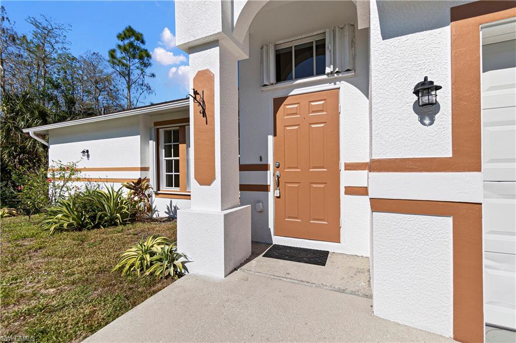 YOUR AFFORDABLE DREAM GOLDEN GATE ESTATES HOME on 1.14 acres. Grassy area around house and rest of property is left in natural state. THREE BEDROOM (3), TWO (2) BATH, 2 CAR GARAGE HOME with screened lanai for the enjoyment of the whole family AND WITH HURRICANE "ACCORDION" EASY CLOSE STEEL SHUTTERS. TILE FLOORS IN THE KITCHEN, HALLS AND WET AREAS AND NEW CARPETING IN THE BEDROOMS. "CHEFS" KITCHEN WITH PLENTY OF COUNTER AND CABINET SPACE AND ALL NEWER STAINLESS STEEL APPLIANCES. Lots of room to play outside. On quiet street but with easy access to Immokalee Road, SCHOOLS, CHURCHES, HOSPITALS, BEACHES, RESTAURANTS and convenient to the shopping area of 951. HOME COMES WITH ONE YEAR COMPLETE HOME MAINTENANCE WARRANTY FOR TOTAL BUYER COMFORT EASY TO SHOW!!