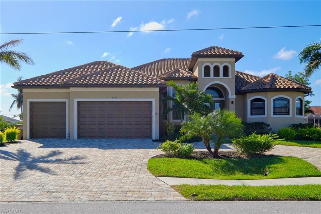 MAJOR PRICE ADJUSTMENT.....  sellers say “get it sold!” Like new SW Cape Coral Gulf Access custom Paul Home. This beautiful home is better than new..... 4 bedrooms plus an office/den, 3 baths, 3 car garage, salt water, heated pool, high ceilings and tray ceilings in most rooms. The home is located just off Surfside Blvd and is surrounded by newer homes. It features southern exposure, tile roof, security system, outdoor summer kitchen, high impact windows and doors and speaking of windows there is an abundance of them making this home very bright. The open floor plan features split bedrooms, great room, separate office/den, diagonal tile floors throughout, great storage and the peace of mind of a monitored security system.  There are too many more upgrades and features to mention here. If it would work for the new buyers, the sellers would like to rent back until the end of May 2018. Can't you just see yourselves lounging by the pool with your tall drink after your boat ride watching our magnificent SW Florida sunset as your dinner is cooking in your outdoor kitchen.  Life at it's best, isn't it your turn to live the Florida lifestyle?