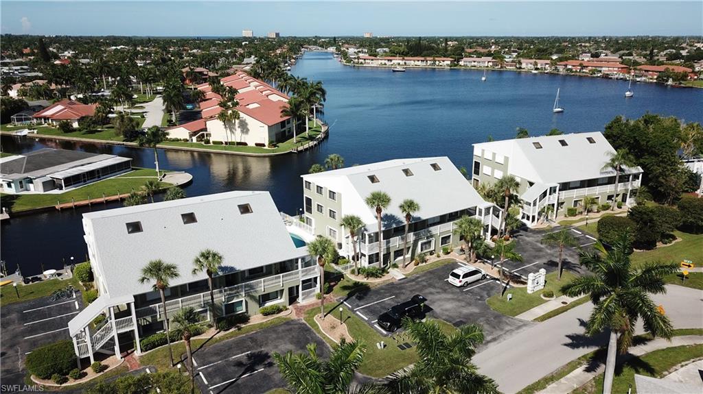 Here is your Chance!! REDUCED!!!!!! WOW You Get Breathtaking Direct Access Waterfront Admirals Walk Condo. Located right on the Bimini Basin.  A direct Sailboat Access Canal and so affordable. This spectacular loft condo has 2 spacious bedrooms and a den. Extra-large Living-room with views to die for. Imagine entertaining on your grand corner unit lanai and watching the Christmas Boat Parade or maybe the 4th of July Fireworks. This lovely condo overlooks the refreshing pool and Captains Walk where you can dock your 30 foot boat! The stunning condo also boasts according hurricane shutters. Just a 2-minute walk to the renowned Four Freedoms Park for recreation or pick-nick. You are located near all the amazing restaurants and nightlife that prominent Cape Coral offers. This home and all its spectacular features are only priced at only $159 a sq ft. Schedule your tour today before it is gone.