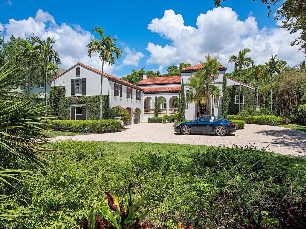 Amazing estate home nestled in gated Bay Creek enclave of Pelican Landing, this fully furnished meandering estate surprises at every turn. A gracious circular drive invites guests to begin their journey to the main entrance through the first inspirational courtyard. Entering the spacious Great Room with 20+ft beamed ceilings and open kitchen you realize that while the exterior design pays homage to a classic European estate the interior is designed for today’s buyers. Great room opens through multiple doors to expansive covered outdoor dining and multi-level plein-air living with pool,  covered sitting area with outdoor kitchen and fireplace, courtyard with fountain and reflecting pool. Updates include new roof, exterior and interior re-paint, Kitchen update, French oak floors in living areas, new entrance, entertainment wall with linear fireplace, updated master bath, new interior/exterior lighting fixtures and more. Owner’s suite features sitting area with fireplace, extravagant bath with claw foot tub and French doors to patio. 4 guest rooms split between main level and 2nd level, 4 full 1 half bath, 2 dens + 3 car garage complete the home. Furnishings  Clive-Daniel+Robb Stuckey