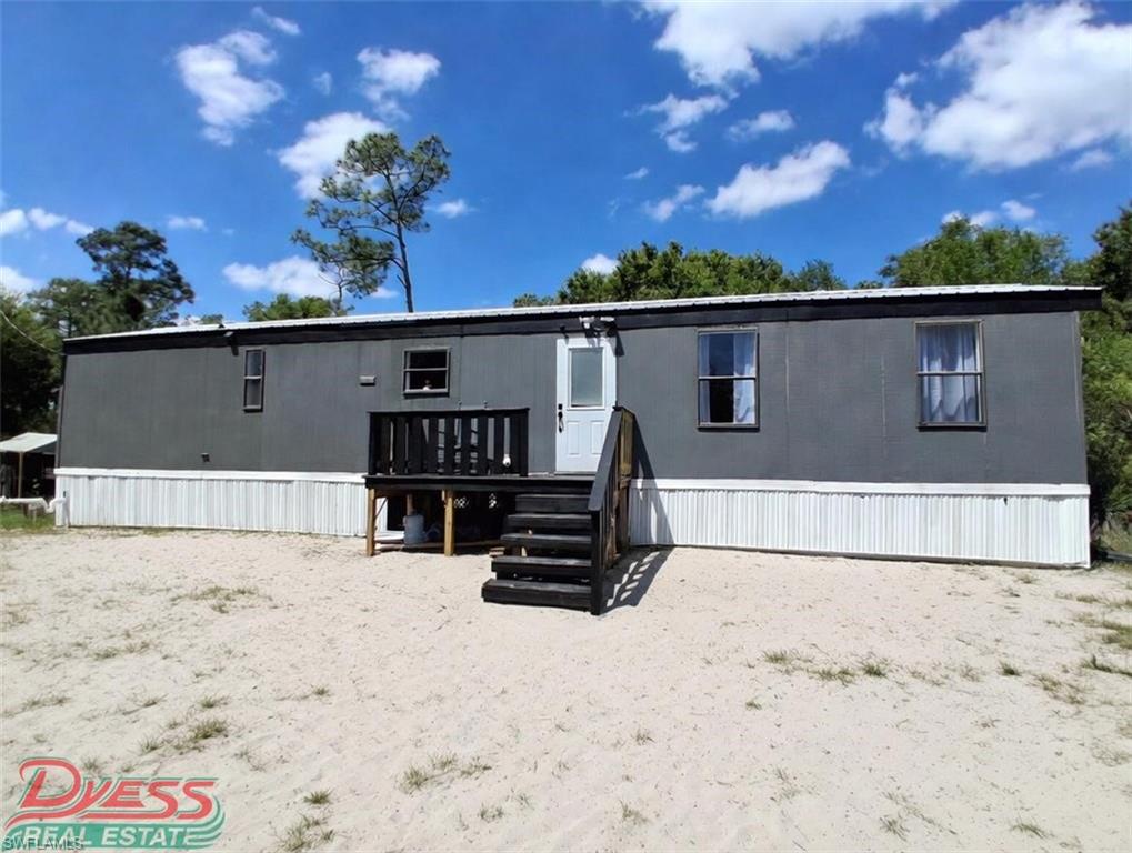 UP for sale in Pioneer Plantation, a golf-cart and horse-friendly community is 2.5 acres with a 1993 SW 56ft x 14ft renovated 2-bedroom 1-bathroom home. Adjacent is another 2.5 acres vacant parcel (801 Wildwood Ave-could be sold separately). Property is a corner lot off Vero Ave and Pioneer 8th spreading until Wildwood Ave. Home has a metal roof and double doors leading out to a 32ft x 12ft screened porch. Well comes with water softener and an above ground pool with the equipment, a deck connecting the pool to the screened porch. The interior of the SW had been renovated with wood flooring and the bathroom boasting smart features such as LED colored light shower head that can match the recessed LED lighting for the room and a Smart LED Vanity Mirror. There is a pond on the property and mature oak trees. Great space for your country living and your toys such as rvs, atvs and more. Pay no city taxes and no HOA's. Community has two convenience stores, community park and room. At the entrance of the community there is a gas station and a Dollar General. 30 min from either Labelle or Clewiston Fl. There is a firehouse located inside the community. Schedule your showing today and enjoy Florida weather year-round.