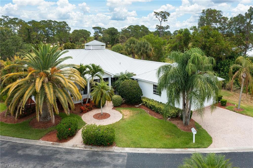 Former Builders Model In Pristine Condition w/ Award winning Design tucked in a quiet secluded Development. One of the most unique properties Riverbend has to offer, At first glance, the cupola, wide front and back porch and metal roof give this home as a uniquely "Florida" aesthetic. Upon entering the first thing I noticed were the tall ceilings contributing to the open airy feel. The kitchen features plentiful cabinet space, a prep island and a counter height bar that can seat up to 6. Along with the breakfast nook, formal dining room and outdoor seating this home has room to accommodate and entertain large groups. Though the master suite is very large, features   a cavernous closet, dual sinks, separate tub and a shower I think the outdoor living space steals the show in this home, the owner enclosed the covered vestibule from Garage to home with a portable A/c creating unique flex space... providing a place for the hot tub, personal gym, art studio, workshop, the options are endless. When it's time to wind down the screened back lanai runs nearly the width of the home, and overlooks preserve and pond views.