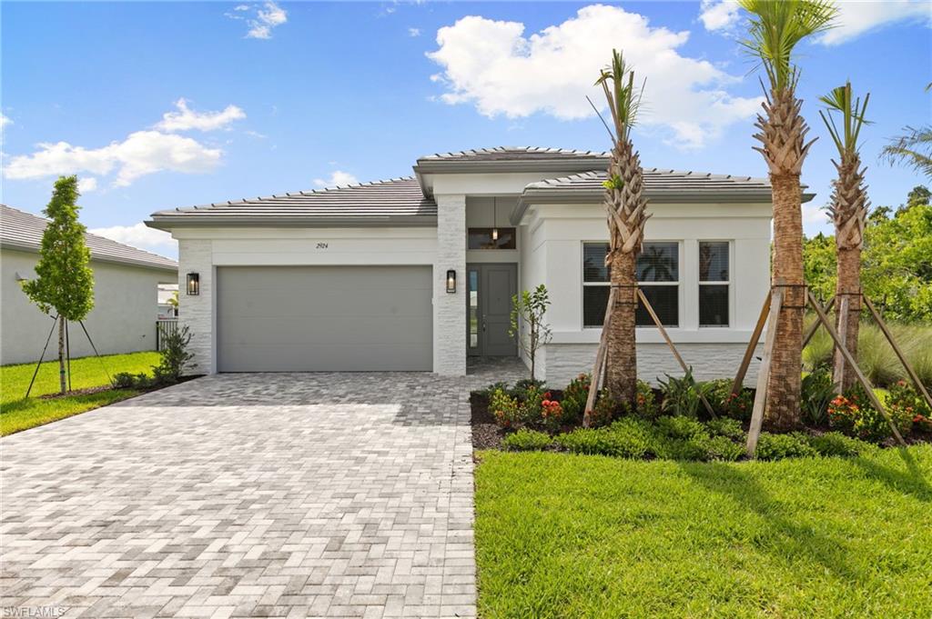 One or more photo(s) has been virtually staged, AI generated or rendered.  Welcome to effortless luxury living in the highly sought-after Valencia Sky community of Naples! This stunning new construction home offers the perfect blend of modern elegance and comfort, featuring 2 spacious bedrooms, a versatile den, and 2 beautifully appointed bathrooms. Designed with today’s lifestyle in mind, the open-concept floor plan is filled with natural light and showcases high-end finishes throughout. The gourmet kitchen flows seamlessly into the main living area—perfect for entertaining or simply enjoying everyday living in style. Step outside to your private retreat and take in serene lake views, creating the ideal backdrop for morning coffee or evening relaxation. The den provides the flexibility for a home office, hobby space, or additional guest area. Located within a vibrant 55+ resort-style community, residents of Valencia Sky enjoy world-class amenities, social activities, and a lifestyle centered around wellness and connection—all just minutes from Naples’ beautiful beaches, shopping, and dining. This is more than a home—it’s a lifestyle. Don’t miss your opportunity to experience the best of Southwest Florida living!One or more photo(s) has been virtually staged, AI generated or rendered.