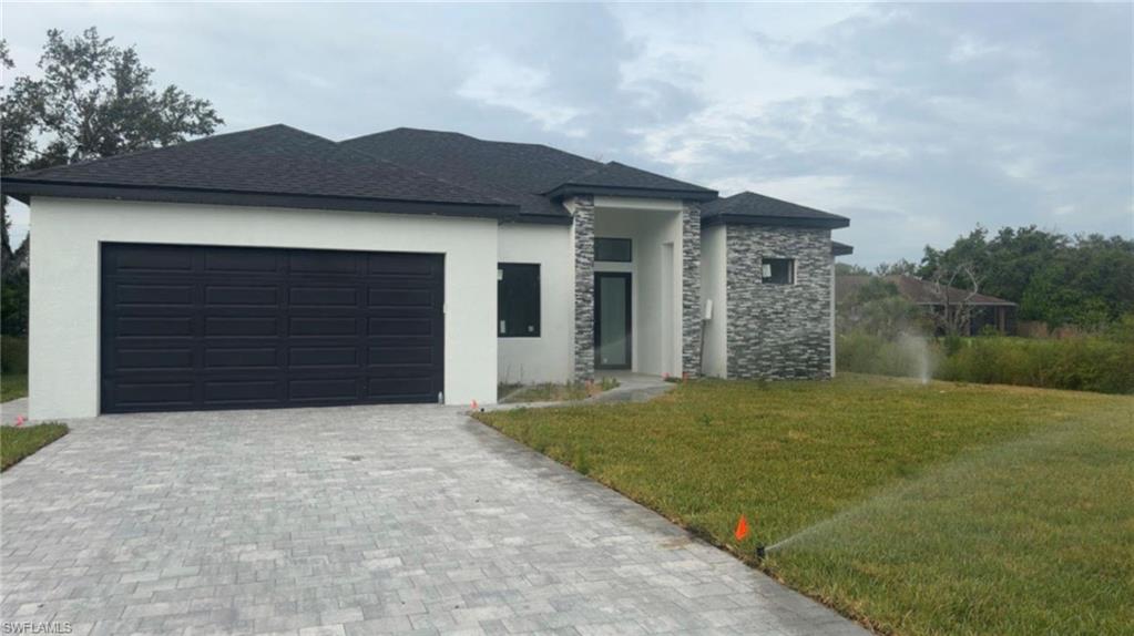 Beautiful modern new construction featuring 3 bedrooms plus a den and 2 full bathrooms with 1735 sq ft of living space. This home offers soaring ceilings, 8 foot interior doors, oversized tile flooring, and a sleek open concept kitchen with a large island and stainless steel appliances. Enjoy Florida living with a covered lanai and outdoor kitchen, perfect for entertaining. Includes sprinkler irrigation system and modern curb appeal with stone accents and paver driveway. Move in ready and conveniently located near shopping, dining, and major roadways.more pictures coming soon !!