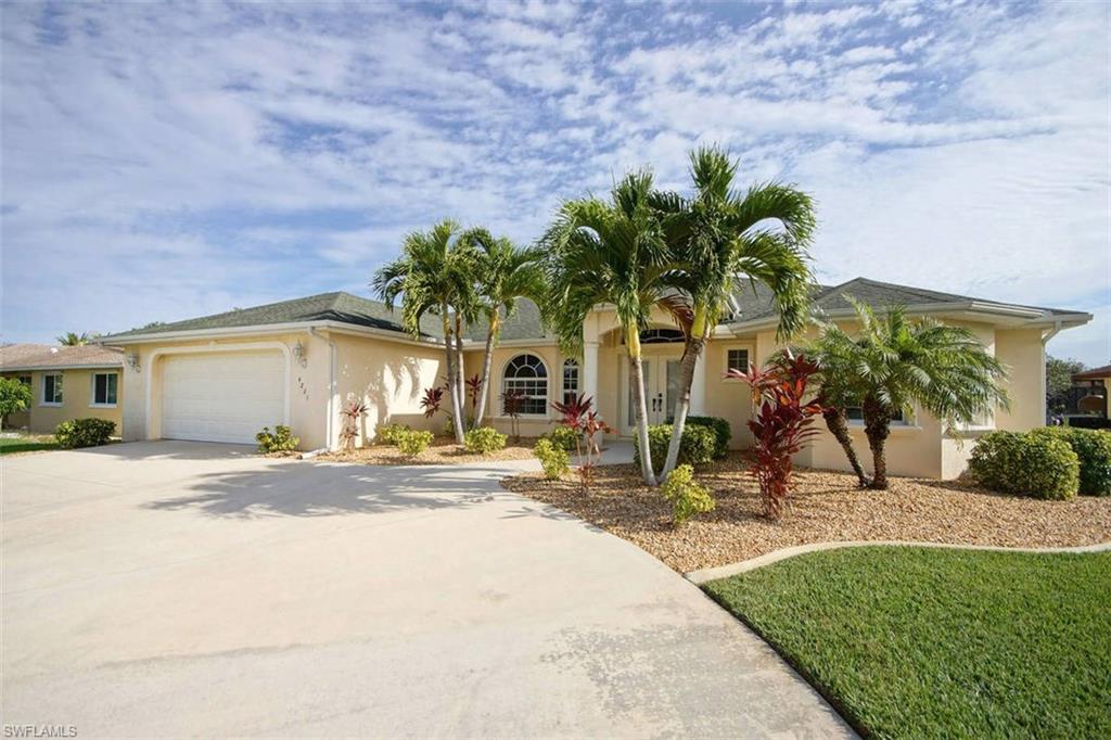 Fantastic Gulf-Access Home with Pool and Spa in Southeast Cape Coral. Built in 2005 and still occupied by the first owner, this home is in like-new condition and was always meticulous maintained. Spacious great-room floor plan with high cathedral ceilings and multiple large windows and sliding glass doors ( entry door & windows in front are impact glass ). Large kitchen with impressive high level granite counter tops and all floors throughout the house are tiled. Master bedroom with tray ceiling and a huge 8' x 6' walk-in closet. Master bath with 2 wide vanities, garden tub and a walk-in shower. Two spacious guest bedrooms with walk-in closets share a shower bathroom also accessible from pool area. Refresh in the free-form 28'x14' electric heated pool and spa with sun-shelf and salt chlorination. Extra deep covered lanai and huge 47'x23' pool deck with natural Travertine stone. Wrap-around boat dock with 12,000 Lbs lift and new canopy fits boats up to 38' long & 10' wide. Only 15 Min to the river, passing many waterfront restaurants. The 9' floor elevation above sea level provides a low cost flood insurance. Circular driveway and underground electric. Numerous tropical palm trees.