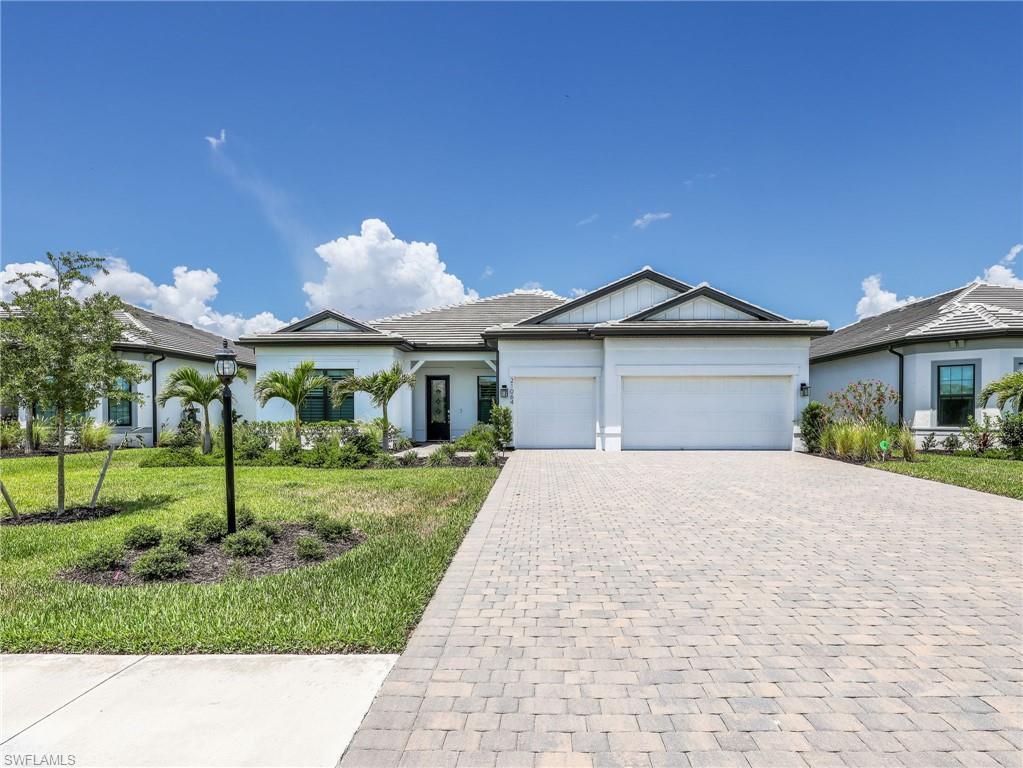 Experience the pinnacle of Southwest Florida luxury living in this exquisite residence located in the highly sought-after community of Verdana Village. Offering 3 bedrooms, 3 bathrooms, a den, and 2,482 square feet of beautifully designed living space, this home perfectly blends elegance and comfort. Step inside to an expansive great room bathed in natural light, where soaring tray ceilings and stunning zero-corner sliding glass doors seamlessly connect indoor and outdoor living. From the moment you enter, breathtaking views of the sparkling lake, private pool, and spa create a serene backdrop throughout the home. Designed for both entertaining and everyday living, the gourmet kitchen is a true showpiece featuring a spacious walk-in pantry, oversized island with breakfast bar seating, wall oven, gas cooktop, abundant cabinetry, and an oversized eat-in dining area perfect for gathering with family and friends. The luxurious owner’s suite is a private retreat, complete with a spa-inspired en-suite bathroom offering dual vanities, a soaking tub, walk-in shower, and generous walk-in closet. Two additional guest bedrooms provide privacy and convenience for family or visitors, while the den offers the perfect flex space for a home office, media room, or additional guest accommodations. Step outside to your personal paradise where the backyard is designed to impress. Enjoy ultimate Florida living with a private pool and spa overlooking the tranquil lake, plus a fully equipped outdoor kitchen with built-in grill ideal for year-round entertaining. Living in Verdana Village means enjoying an unparalleled resort lifestyle with world-class amenities. Residents have access to a one-of-a-kind in SWFL indoor sports complex featuring pickleball, tennis, and basketball courts complete with a scoreboard, along with additional outdoor sports courts, a resort-style pool and spa, indoor and poolside dining, fitness facilities, and endless opportunities for recreation and relaxation. This extraordinary home is the true epitome of luxury Southwest Florida living. In the perfect location, Verdana Village is just minutes away from shopping centers, fine dining, RSW International Airport, I-75, and white sandy beaches. Call to schedule your showing today!