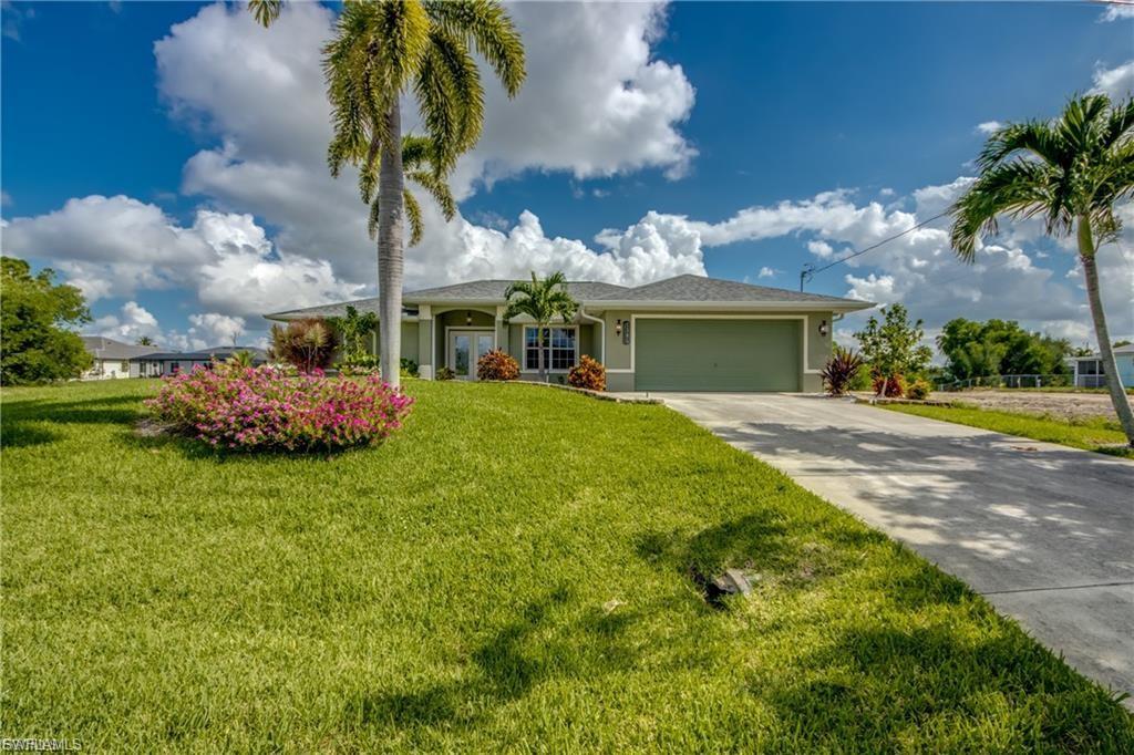 Don't miss this incredible opportunity to own a beautifully updated 3-bedroom, 2-bath home built in 2005 with high ceilings, city utilities, and NO HOA. Located outside of a flood zone, this canal-front property offers privacy, comfort, and Florida living at its finest. The updated kitchen features granite countertops and an impressive suite of premium appliances, all less than one year old, including a Lofra induction range imported from Italy, Samsung Bespoke refrigerator with self-fill pitcher and Wi-Fi connectivity, Samsung Bespoke dishwasher, and Samsung microwave. The home also features updated bathrooms, tile and laminate flooring throughout (no carpet), ceiling fans throughout, and an irrigation system. The spacious great room and dining area feature glass pocket sliders that fully open to the outdoor living space, creating the perfect setting for entertaining. Enjoy the saltwater, in-ground heated pool, covered lanai, and outdoor string lighting while overlooking the freshwater canal. Some furniture will convey, making this home even more move-in ready.The primary suite is generously sized and offers private access to the pool through glass pocket sliders, a large walk-in closet, dual vanities, an oversized tiled walk-in shower, and a private water closet. The split-bedroom floor plan provides excellent privacy for owners and guests alike. Recent updates include a new roof in 2023, AC in 2021, and Kevlar screens for storm protection. The two-car garage offers ample room for vehicles, storage, or hobbies. Launch a kayak, fish from your dock, or enjoy boating on the freshwater canal and nearby lake. Conveniently located near shopping, restaurants, schools, healthcare facilities, and just minutes from Downtown Cape Coral, the Pine Island Corridor, Downtown Fort Myers, Punta Gorda, and Pine Island. Spend your days enjoying world-class fishing or exploring North Captiva, Cayo Costa, Boca Grande, Sanibel, and Captiva Islands.