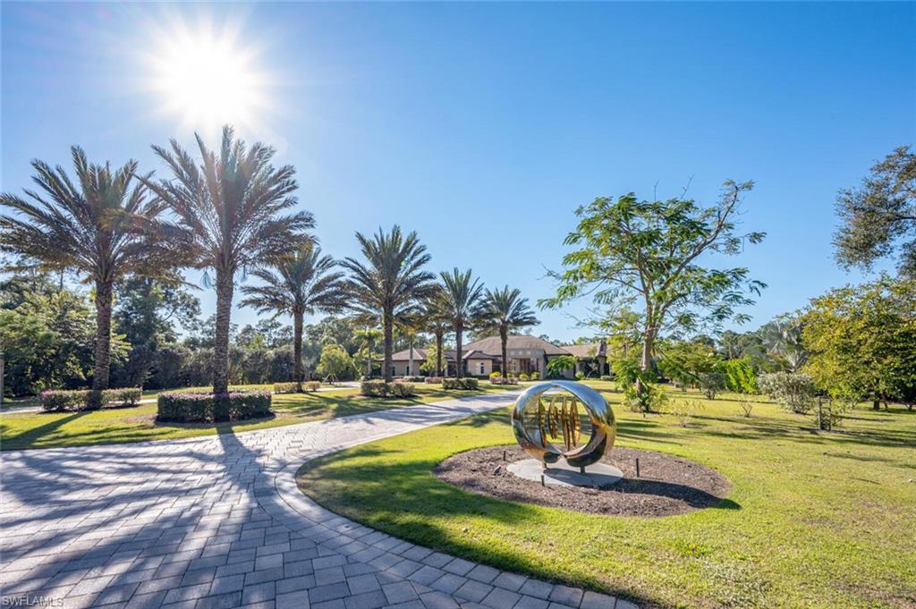 Lavish Estate home has too many features to list! Once you enter the secure gate, the winding driveway and porte-cochere welcome you. Step through the double door entry and you have "arrived"!  A massive Great Room opens to an unbelievable pool, spa, deck and entertaining area with an over-sized summer kitchen, an outdoor fireplace all overlooking the magnificent 4.5 acre (+/-) property with lush landscaping, a bounty of trees, shrubs, and lovely mature palms. A cart path meanders through the acreage past the oversized out building, fruit trees, orchid house and well manicured grounds. The spacious primary suite & luxury bath are all on one side of the home with wonderful walk-in closets, two dens, as well as tons of built-ins and a coffee nook. All the suites are grand and offer privacy. The gourmet kitchen has a double island, a commercial sized refrigerator/freezer, a butlers pantry, and so much more! If you are looking for the ultimate estate with quality construction, close to everything yet feeling like you are in the middle of nowhere, then this home checks off all those boxes! Did we mention the 1500+ bottle wine room, the 4-car garage and built-in tropical fish tank?