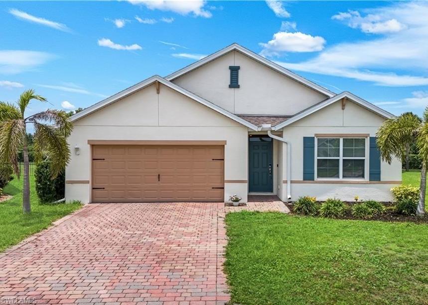 Welcome to the beautiful CALI FLOOR PLAN HOME ... BUILT IN 2020 ... Enjoy Florida living in this IMPECCABLY maintained home featuring 4 bedrooms, 2 full bathrooms.   This stunning home has upgraded fans w/ light fixtures. The sliding glass door opens up to the AMAZING, peaceful lanai and extra large outdoor space for the best outdoor entertaining!  The interior features tile flooring throughout the the main living area of the home. Inside the great room invites natural light for seamless indoor living. The gourmet kitchen showcases beautiful stone countertops, a spacious center island, ample prep space and a large walk-in pantry. The primary suite is a private retreat with a walk-in closet, separate full closet, dual sinks, and a walk-in shower.   The dining room, offers tranquil views of the peaceful lanai.  A 2 car garage with space for 4 cars on the brick-paver driveway provide ample parking and storage. Set on an expansive homesite, this residence blends privacy with proximity to the best of Southwest Florida. Entrada Subdivision hosts an amazing pool, club house, play area, tennis, pickle ball, lap pool, gym, and much more!!  Experience unparalleled luxury, comfort, and location here, an absolute must-see!!