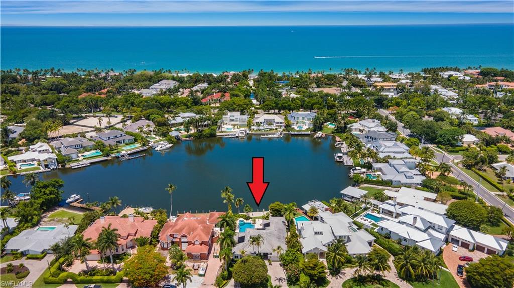 Spectacular wide water views! Rare west facing lot in Aqualane Shores. Fabulous location on Aqua Cove, just blocks to the beach or downtown 3rd St. S. for shopping, dining and entertainment. Spacious floor plan with expansive living room plus Florida room, formal dining room and kitchen opening to family room. Split bedroom layout has Master suite with sitting room, walk in closet and bath with dual sinks, separate tub and shower plus four guest bedrooms and a den. Outdoor living boasts lush landscaping, large pool with spa, built in grill and 50’+ boat dock with lift. As this home has been rented for much of the years new buyer may enjoy significant rental income when not using the home.