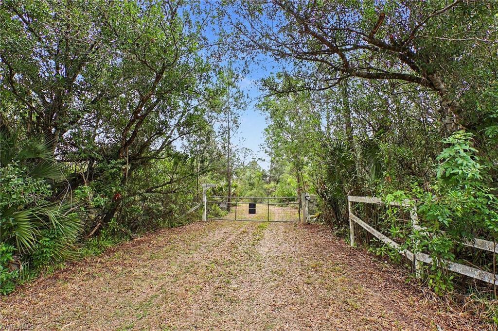 **A Rare 55-Acre Estate Opportunity in North Fort Myers**
Tucked away yet remarkably close to everyday conveniences, this extraordinary 54-acre property at **20800 Williams Road, North Fort Myers** offers a rare opportunity to own a true piece of Florida paradise. A private, improved roadway gently winds deep into the property, unveiling a breathtaking landscape of mature wooded areas, year-round ponds, manicured trails, and a stunning elevated homesite overlooking a deep, scenic lake.
Designed for those seeking space, privacy, and endless possibilities, this remarkable acreage provides the perfect canvas for a custom estate, family compound, farm, recreational retreat, or legacy property. The homesite is thoughtfully positioned to take advantage of the natural beauty and tranquility of the land, with electric service being extended to the property to support your vision.
For the outdoor enthusiast, the property offers exceptional recreational potential, including a private shooting range area with a large protective berm, creating a dedicated space for personal enjoyment and practice. The expansive acreage allows room to explore, create, and truly embrace the freedom of country living.
Located along the Lee and Charlotte County line with convenient access from a paved road, this unique property delivers the rare combination of privacy and accessibility. Enjoy the peace and seclusion of wide-open acreage while remaining just minutes from shopping, Interstate access, and the popular local farm-to-table destination, Blossom and Brie.
Properties of this size, character, and location are increasingly difficult to find. Whether you envision a private estate, family retreat, agricultural use, investment opportunity, or a place to enjoy the outdoors, 20800 Williams Road offers the space and flexibility to bring your dreams to life. Schedule your private showing today and experience this extraordinary Southwest Florida property. This is the one you have been dreaming about.  Do not enter the property without making an appointment with the listing agent.