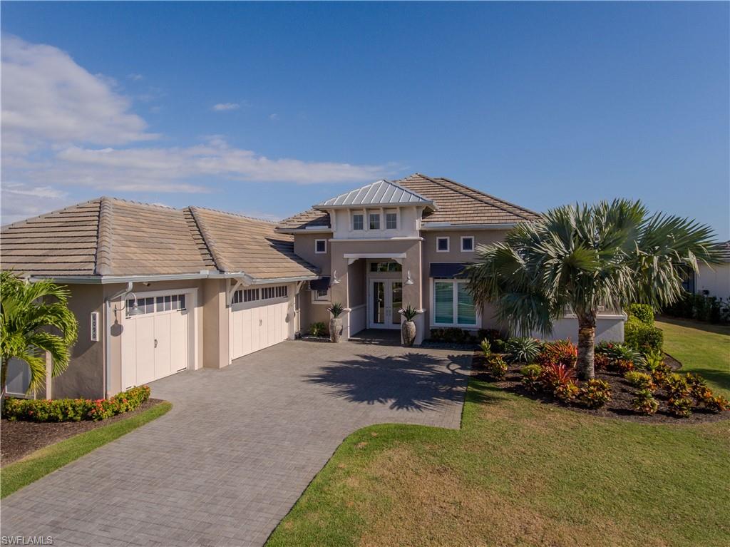 Welcome to the most elegantly designed, option-loaded, award-winning Stock-built Cocoplum home.  Located in a No Flood Zone inside the highly desirable Isles Of Collier Preserve with breathtaking sunrise and sunset views from your lanai. With many custom features, hundreds of thousands in options including built-in Thermador Appliances, tiled floors throughout the complete home, coffered ceilings with innovative lighting, and custom-designed wall features.  Uniquely designed custom showers in each of the 4 en-suite bathrooms.  The Primary bedroom showcases an elegant John Richards chandelier, custom-designed his and her walk-in closets, and a private walk-out to the lanai.  The spacious north-facing cul-de-sac lot is professionally landscaped with cascading palm trees to further enhance the outdoor beauty of this home. This spacious property boasts 5500 total square ft, including 3693 sq ft under air, to enjoy and entertain.  Don't miss out on your opportunity to fall in love with this stunning luxury home!