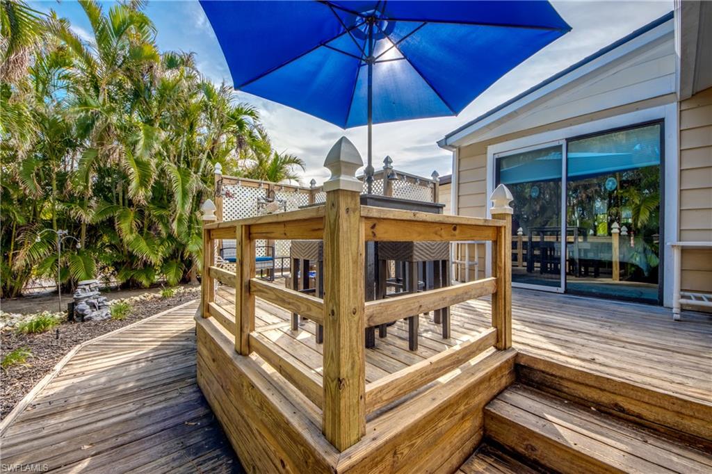 HUGE PRICE REDUCTION MOTIVATED SELLERS SAY MAKE ME AN OFFER!! 55+ GULF ACCESS BOAT RAMP for fishing and boating enthusiasts! St. James City is known for its secluded and relaxed atmosphere and that is exactly what this home possesses, plus more!! This home sits on a CORNER LOT which provides privacy and space! Step inside this immaculate 2 bedroom 2 bath home with many updates and finishes.  Each bedroom offers an ensuite bath complete with spacious closets.  The kitchen comes well equipped with nice appliances.  The living room is inviting and bright.  Just off the living room you will be delighted to have a beautiful Florida room fit for even more guests.  This room would also make a nice office or gym.  An outdoor oasis awaits, with access from either bedroom.  Enjoy watching the game with friends in your screened in porch or enjoy cocktails and the most gorgeous sunsets amongst the breeze.  Just steps off the deck is a Tiki Hut that has a Grill for BBQ's and entertaining guests! This home also includes a Wen 50 AMP HOME GENERATOR W/100 LB. PROPANE TANK!!   Amenities galore including Clubhouse, heated pool & spa, pickleball, bocce and dog park! Need a place to store your boat or RV? No problem! Gated storage available!!