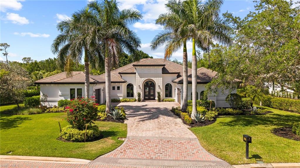 Behold this graciously appointed home sitting on the 9th tee of the preserve course.  When you step thorough the double glass front door to the stunning foyer, you will immediately be immersed in luxury. The soaring ceilings greet you and offer the spectacular opening to the great room flanked by the formal dining room and den and leading your eyes to the luxurious lanai. A cozy fireplace and large kitchen island anchor the great room for fabulous entertaining and the additional flex room can be used for a multitude of purposes and opens also to the lanai with pocketing sliding doors.  The kitchen is a delightful space to use your imagination and create culinary delights, double ovens, wall oven, gas cooktop, walk in pantry and all the bells and whistles you can ask for to release your inner chef! Immerse yourself in the gorgeous primary suite, generous and able to accommodate a seating area as well as your king-sized furniture and a private French door to the lanai for quiet respite. After a well enjoyed day in SWFL you can pamper yourself in the primary spa inspired bath with large shower, soaking tub and double vanities.  2 additional bedrooms and baths are simply divine for family and guests.  The exceptional lanai features a wood ceilinged gathering space including a full outdoor kitchen, seating area with fireplace and dining space and all overlooking the superb inground heated pool/spa and water feature wall. Updates include HVAC in 2024/25.  Offering a transferrable House Membership.