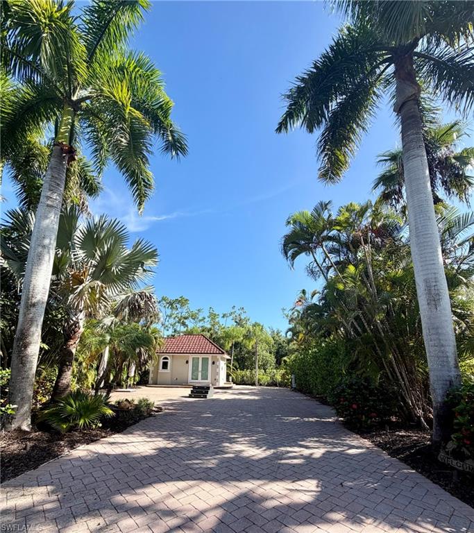 Site Details:
Back-in to this off-lake site located towards the northern/east end of Pelican Lake Motorcoach Resort.  Upgraded and finished with tasteful finishings including a full paver pad with extended patio, 308 square foot coachhouse, and private, tropical landscaping to create great privacy.  This property is spacious and spans approximately 5300 square feet.  Nice room for outdoor entertaining and relaxing!
Coach house Details: 
The 308 square foot coachhouse was custom built in 2018 and is positioned in the north/east corner of the site.  The positioning of this coachhouse creates a large area towards the front of the property for living and a perfect place for a new screen room if one desires.  The coachhouse has recently been painted on the interior and exterior.  The floor plan consists of a full kitchen with sit up counter, bathroom with standalone shower, living area and loft.