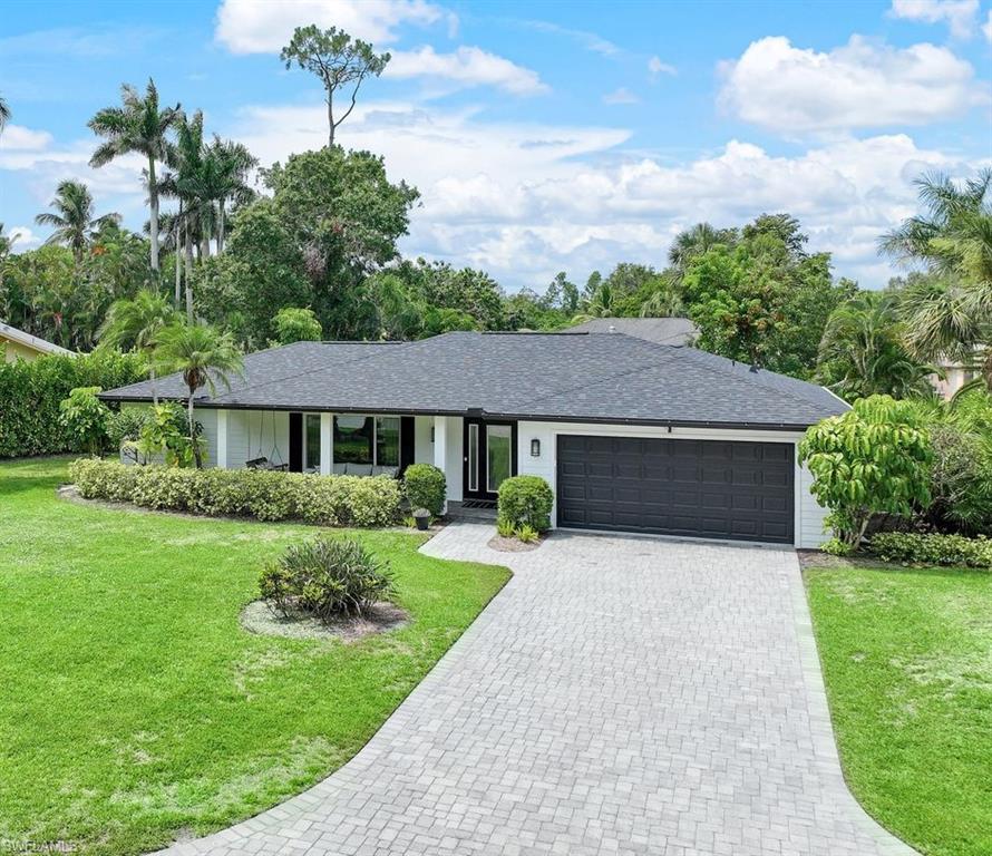 Stunning 3 bed, 2 bath southern exposure pool home brimming with updates and designer touches galore on a quiet cul-de-sac in the highly sought-after Victoria Park II community. Impressive updates include a new roof (June 2022), energy-efficient high-impact windows, and newly surfaced pool brick pavers. The reimagined kitchen boasts Cambria counters, white-and-gray shaker-style cabinetry, a built-in pantry, and Bosch and Samsung appliances. The spacious master bedroom offers a closet with custom cabinets and an ensuite bath with dual vanities, granite counters, and a walk-in shower. Additional features include an open floor plan, 2 living areas (one can double as flex space), large diagonal tile throughout, a sprawling screened lanai with a lagoon-style pool and seating/dining areas, a 2-car garage with additional storage racks, and a large front and backyard. Victoria Park II amenities include lighted tennis courts, a family park, private lake boat dock, and a community pool. Ideally located minutes from Waterside Shops, Mercato, Delnor Wiggins State Park, and Vanderbilt Beach.