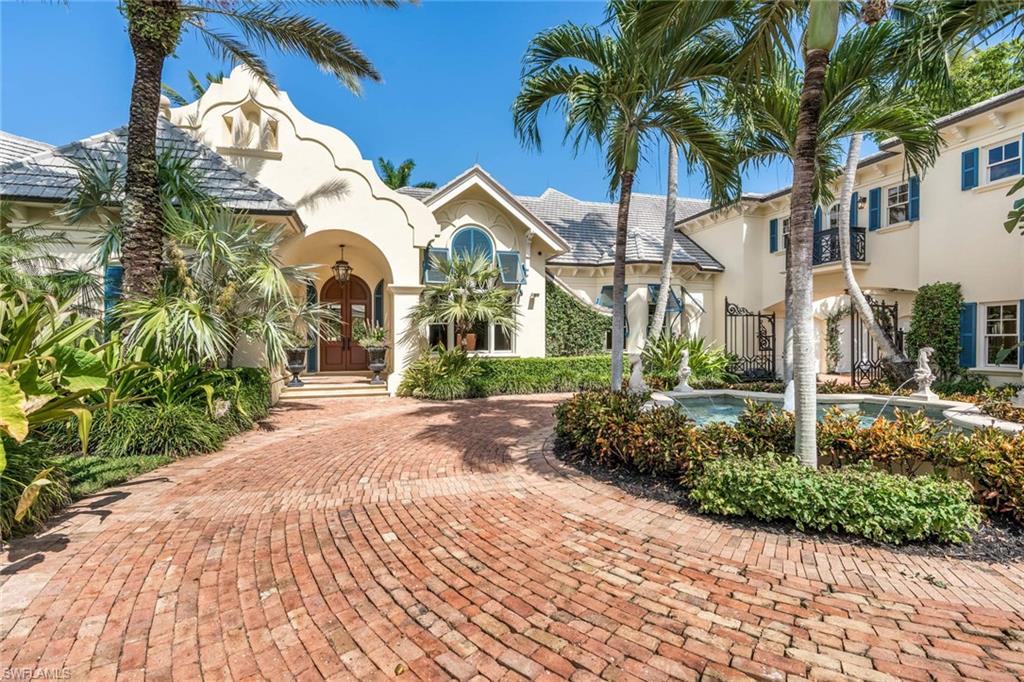 An exceptional property even among the exclusive, this custom-designed Port Royal residence steps from the iconic beach club, featuring 276 feet of water-frontage and 100-foot dock along Old Harbour Cove. The 5-bedroom, 6 bathroom Bermuda-inspired home, including a 957 square-feet detached guest house, designed by premier architect Jeff Harrell, sits on a more than 36,000-square-feet cul-de-sac lot, sweeping waterfront pool terrace, covered gazebo, koi pond, and impeccable grounds ensuring your enjoyment. Details abound throughout this gated estate, crafted with unmatched materials and finishes. Endless list of extras, from the butler’s kitchen and wine cellar to the home theater and commercial-grade kitchen appliances, endow the home with tranquil grandeur. The docks two lifts are optimal for your boating needs and only minutes to Gordon Pass and Gulf of Mexico. Additional noteworthy amenities include a master suite safe room, 6-car air conditioned garage, and 2 half-baths.