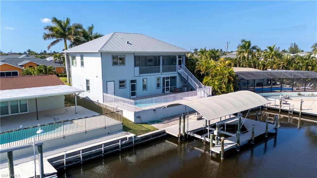 Discover a true waterfront escape in unincorporated Matlacha Isles where quiet island living, direct Gulf access, and modern hurricane-built construction come together in one rare property. Built in 2015 to updated Florida hurricane codes, this home has already proven its strength—two of the most significant hurricanes in state history impacted the area during ownership, and there was no flooding in either storm, with only minor siding damage on the west side while the rest of the home held strong. The property sits on a deep, wide canal with no bridges, offering fast boating access to Matlacha Pass, Cayo Costa, Boca Grande, Pine Island Sound, and some of Southwest Florida’s best fishing waters. Major waterfront improvements provide long-term peace of mind, including a fully rebuilt seawall (significant investment), reinforced dock, fully serviced boat lift with updated gears and electrical, and a brand-new $7,000 canopy. Both front and rear steps were rebuilt with updated railings, enhancing durability and curb appeal. A heated pool allows year-round enjoyment, supported by a newer pool heater and automatic-fill system for easy maintenance. Inside, natural light fills the open layout with relaxing canal views from the main living spaces, creating ideal indoor-outdoor flow for entertaining, seasonal living, or full-time residence. Located in unincorporated Matlacha Isles, owners enjoy fewer municipal restrictions while being minutes from the colorful Matlacha arts district, waterfront dining, kayaking routes, and the surrounding aquatic preserves. This is a rare opportunity to own a post-2015 built, storm-resilient, Gulf-access waterfront home in one of Southwest Florida’s most distinctive boating communities.