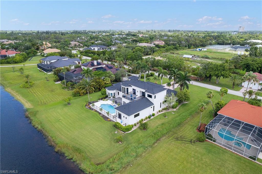 Fully renovated lakefront estate in the prestigious gated community of Devonwood Estates! This exceptional 6-bedroom, 5 full and 2 half bath residence offers 5,651 sq ft of luxurious living on a rare lakefront lot with panoramic views of Lake Devonwood. Designed for both everyday living and entertaining, the home features a grand spiral staircase, private elevator, gourmet kitchen with gas range and premium appliances, hidden walk-in pantry, dry bar, formal living and dining rooms, dedicated office, gym/6th bedroom, and a spacious upstairs library/lounge. The open-concept kitchen flows seamlessly into the expansive family room, creating an ideal gathering space for family and guests. The first-floor primary suite offers a spa-inspired bath and custom walk-in closet, while each upstairs bedroom enjoys a private ensuite. Outdoor living is equally impressive with a resort-style pool, outdoor kitchen, covered lanai, and dedicated pool bath all overlooking the lake. Additional upgrades include a 2023 stone-coated metal roof, 2024 impact windows, and two oversized garages, one air-conditioned with a mini-split system. Devonwood residents enjoy access to community tennis, pickleball, basketball, private boat storage, and a Gulf-access boat launch. Ideally located just minutes from shopping, dining, Gulf beaches, top-rated hospitals, and Southwest Florida International Airport (RSW), this exceptional estate offers luxury living with unmatched convenience.