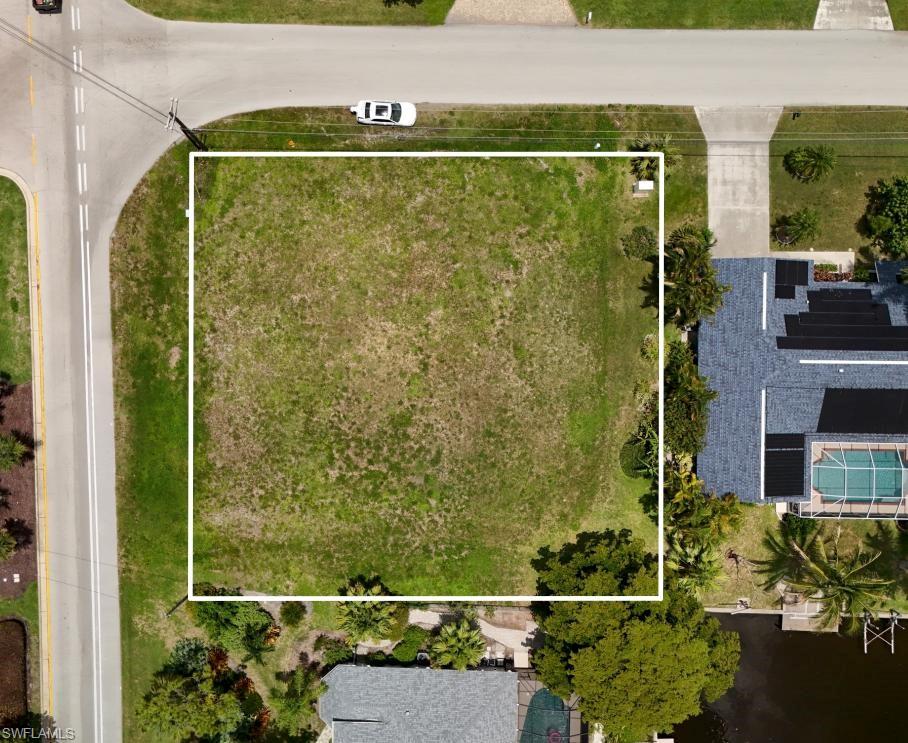Rare opportunity to own an oversized 0.36-acre corner residential lot (Parcel ID: 32-44-24-C2-01204.0310) in the highly desirable SE Cape Coral area. This spacious property offers water views of the Hudson Canal and is just minutes from the public boat ramp at Herman Horton Memorial Park, providing convenient access to the Caloosahatchee River and the Gulf. Ideally located near Del Prado Blvd. and Veterans Pkwy., with easy access to shopping, dining, schools, and the Midpoint Bridge to Fort Myers. Public central water and sewer available. Electric service available nearby; buyer to verify utility connection costs and future assessments with the City of Cape Coral.