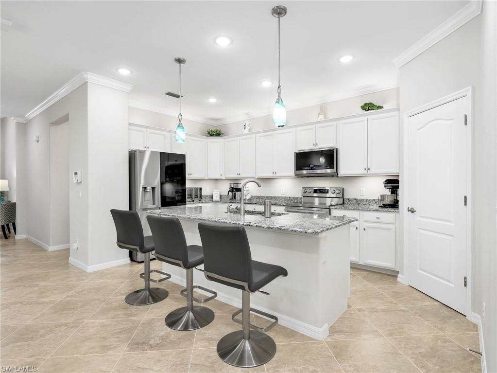 Welcome to your METICULOUSLY upgraded dream home at 4383 Bismark Way, nestled w/in the gated community of Raffia Preserve! Conveniently located North Naples, this exceptional 4 bedroom, 3 full bathroom home spans 2,032 sq ft with a 2-car garage. Inside, the home exudes sophistication w/ crown molding flowing through the kitchen, hallway, master suite & living areas, beautifully complemented by stylish tile in the main living areas & Pergo laminate flooring in the bedrooms (NO CARPET!). Additional features include upgraded track lighting & premium ceiling fans in all bedrooms (brand new in primary), living area, and lanai. The gourmet kitchen is a chef's delight, boasting brilliant under & above cabinet lighting along w/ a suite of BRAND NEW premium LG appliances including a refrigerator w/ a craft ice maker, microwave, range (all in 2026) & dishwasher (in 2025), pendant lighting, as well as a walk-in pantry & an island. Convenience meets organization in this laundry room which features a built-in tall cabinet for extra storage plus a hanging rack & shelf & BRAND NEW 2026 LG washer & dryer. Bathrooms have been beautifully refreshed w/ new hardware & showerheads, a new faucet in the separate guest bath & a seamless glass enclosure paired with a framed mirror & a large vanity w/ dual sinks in the primary suite (see features list for more details). The primary suite also includes dual walk-in closets w/ custom built-in organizers! The 2 car garage is equipped w/ a manual generator throw switch (for either a whole home generator or a portable unit), carbon monoxide detector, recessed lights, exhaust fan & useful utility sink. Designed for maximum energy efficiency, comfort & state-of-the-art technology, the home includes upgraded R38 blown fiberglass insulation, a whole-house Aquasana water filtration system, an HVAC UV light, a cell phone signal booster, lightning-fast 1G Quantum Fiber Internet through the HOA & extensive Cat 8 cabling throughout. Advanced smart home security is at your fingertips w/ a Honeywell WiFi thermostat, a new Kwikset front door keypad & an REO Link security setup offering 4 cameras & a video doorbell. Verticell shade on the lanai sliders leads to the expansive paver lanai to your private outdoor sanctuary overlooking the beautifully upgraded backyard landscaping w/ a peaceful lake view. COMPLETE & CONVENIENT HURRICANE PROTECTION includes an electric AHT screen & roll-down screen on the lanai, accordion storm shutters on the sides & back primary bedroom window & roll down screens on front door & front window. Residents enjoy a resort-style community pool w/ lap lanes, basketball court, sidewalks throughout the community, clubhouse w/ community room, exercise room, tot lot & 72 acres of breathtaking nature preserves & lakes, all conveniently located just 8 miles from Vanderbilt Beach. Prime location in North Naples w/in just 5 minutes to Founders Square featuring many restaurants to choose from!