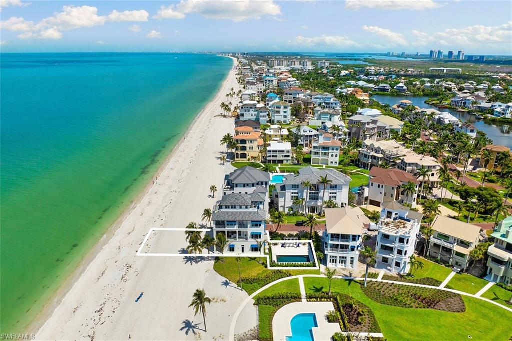 Positioned on a double Gulf-front lot in Barefoot Beach, this estate offers unmatched privacy, exclusivity and potential. Spanning 7,490 square feet, the custom Potter Homes residence blends timeless craftsmanship with modern elegance, featuring rich wood flooring, expansive glass walls, and seamless indoor-outdoor living. Go onto the wrap-around balcony and savor panoramic Gulf views, where every sunset feels like a private performance. Entertain in the chef’s kitchen, retreat to the serene primary suite with spa-inspired bath and coffee bar, or host guests in multiple en-suite bedrooms, including a third-floor suite with its balcony. Outside, a private pool oasis awaits, framed by lush landscaping and just a short distance from the sand. This is a once-in-a-lifetime offering, a rare double-lot estate with endless possibilities for possible second residence, expansion, investment, or creating a multi-generational Gulf-front compound (independent verification recommended for all options). Optional membership to the Club at Barefoot Beach (waitlist applies). Club amenities such as dining, bars, poolside service and tennis, all in a gated, exclusive enclave.