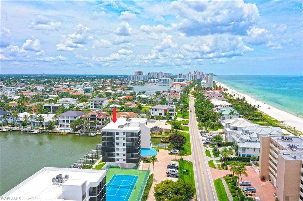 This exceptional home offers an unparalleled package deal, featuring a stunning top-floor view of breathtaking Bay and Gulf views! In addition, with a private beach access. On the penthouse top floor, directly off the elevator, and boasts an oversized primary with Gulf views and a second bedroom overlooking the bay and city lights. This home has been completely renovated with exceptional design and product. All new top-of-the-line appliances and products. In the heart of Vanderbilt Beach, this home provides convenient access to the gulf and beach, offering unparalleled views and a vibrant culinary scene with renowned restaurants and the LaPlaya Beach and spa resort across the street. A tropical vacation destination or a lucrative investment piece of paradise. In addition, if available, there are beach suites and boat slips on the bay side of the building.